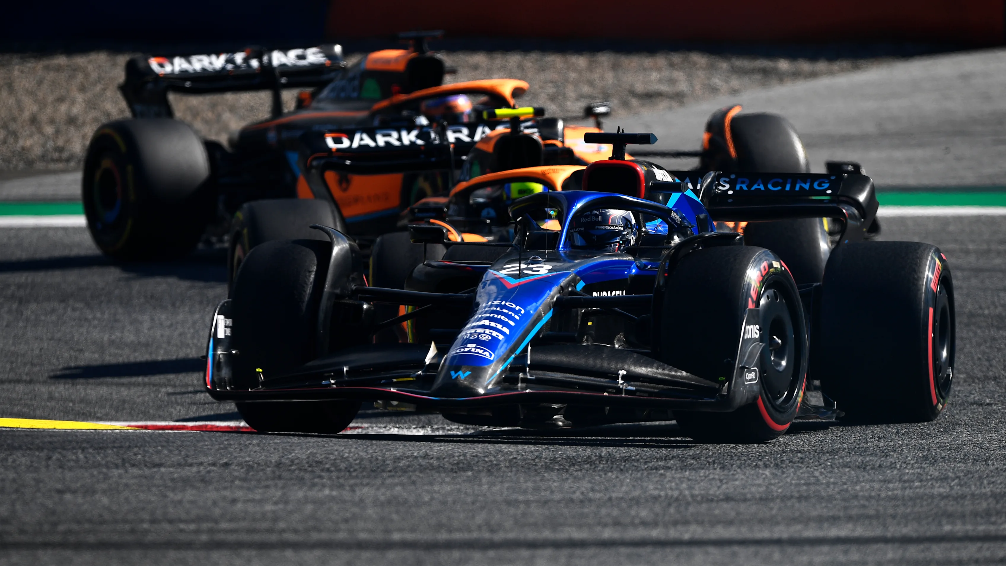 SPIELBERG, AUSTRIA - JULY 09: Alexander Albon of Thailand driving the (23) Williams FW44 Mercedes leads Lando Norris of Great Britain driving the (4) McLaren MCL36 Mercedes and Daniel Ricciardo of Australia driving the (3) McLaren MCL36 Mercedes during the F1 Grand Prix of Austria Sprint at Red Bull Ring on July 09, 2022 in Spielberg, Austria. (Photo by Rudy Carezzevoli - Formula 1/Formula 1 via Getty Images)
