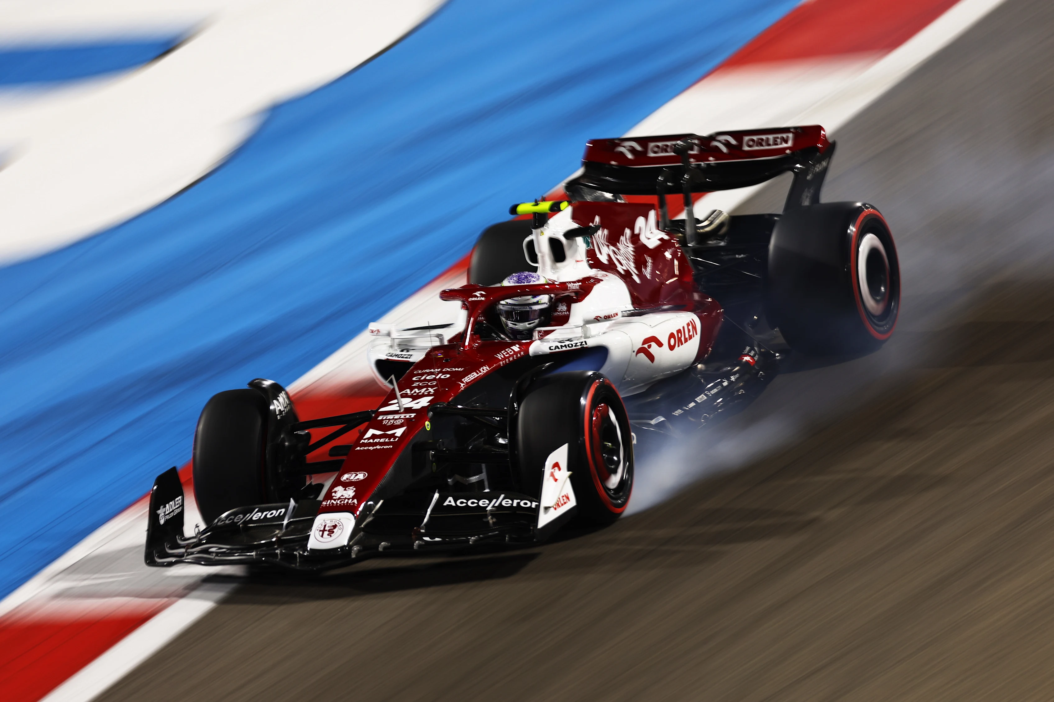 BAHRAIN, BAHRAIN - MARCH 19: Zhou Guanyu of China driving the (24) Alfa Romeo F1 C42 Ferrari locks a wheel under braking during qualifying ahead of the F1 Grand Prix of Bahrain at Bahrain International Circuit on March 19, 2022 in Bahrain, Bahrain. (Photo by Lars Baron/Getty Images)