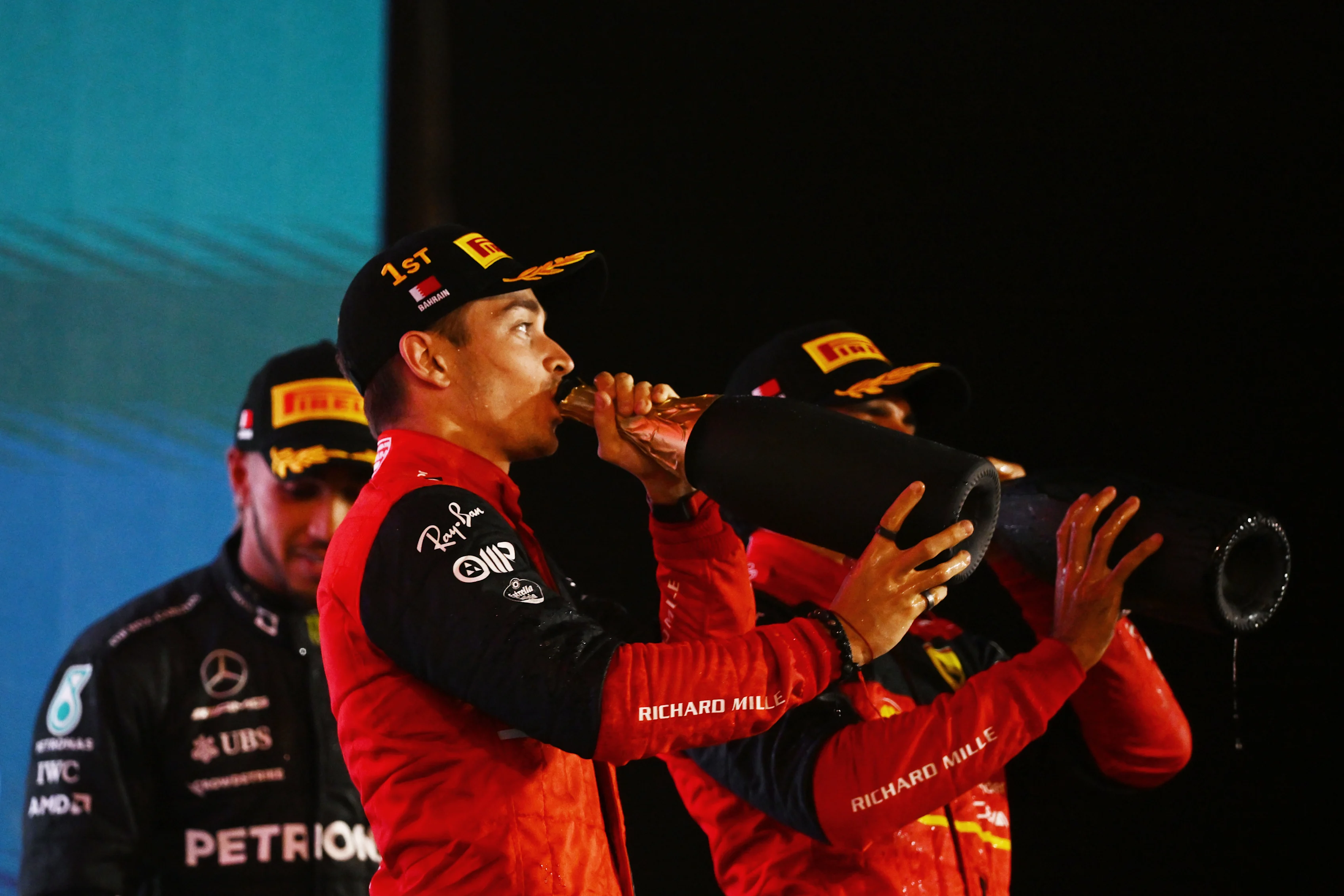 BAHRAIN, BAHRAIN - MARCH 20: Race winner Charles Leclerc of Monaco and Ferrari celebrates on the podium during the F1 Grand Prix of Bahrain at Bahrain International Circuit on March 20, 2022 in Bahrain, Bahrain. (Photo by Clive Mason/Getty Images)