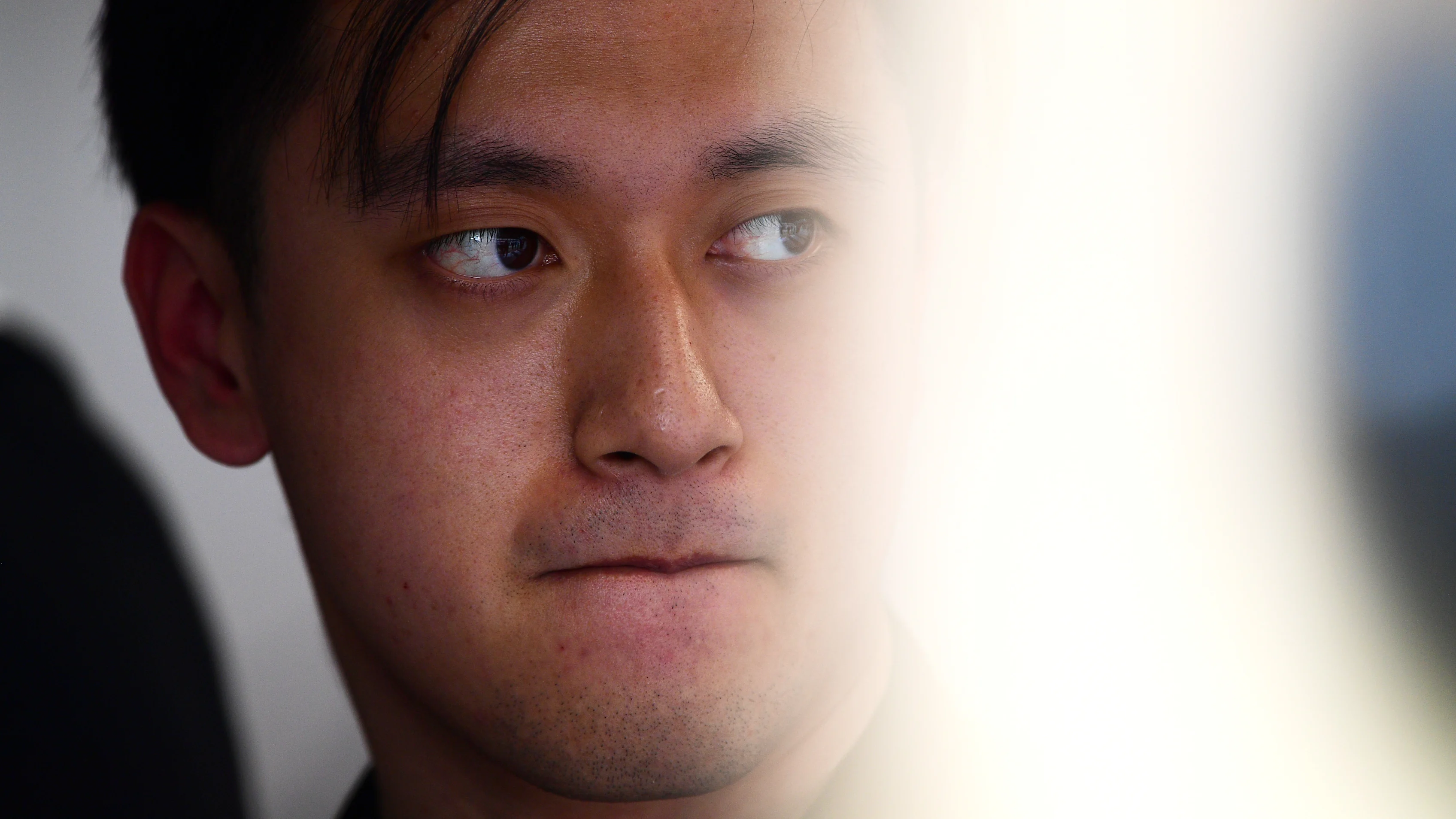 BARCELONA, SPAIN - FEBRUARY 25: Zhou Guanyu of China and Alfa Romeo F1 looks on in the garage