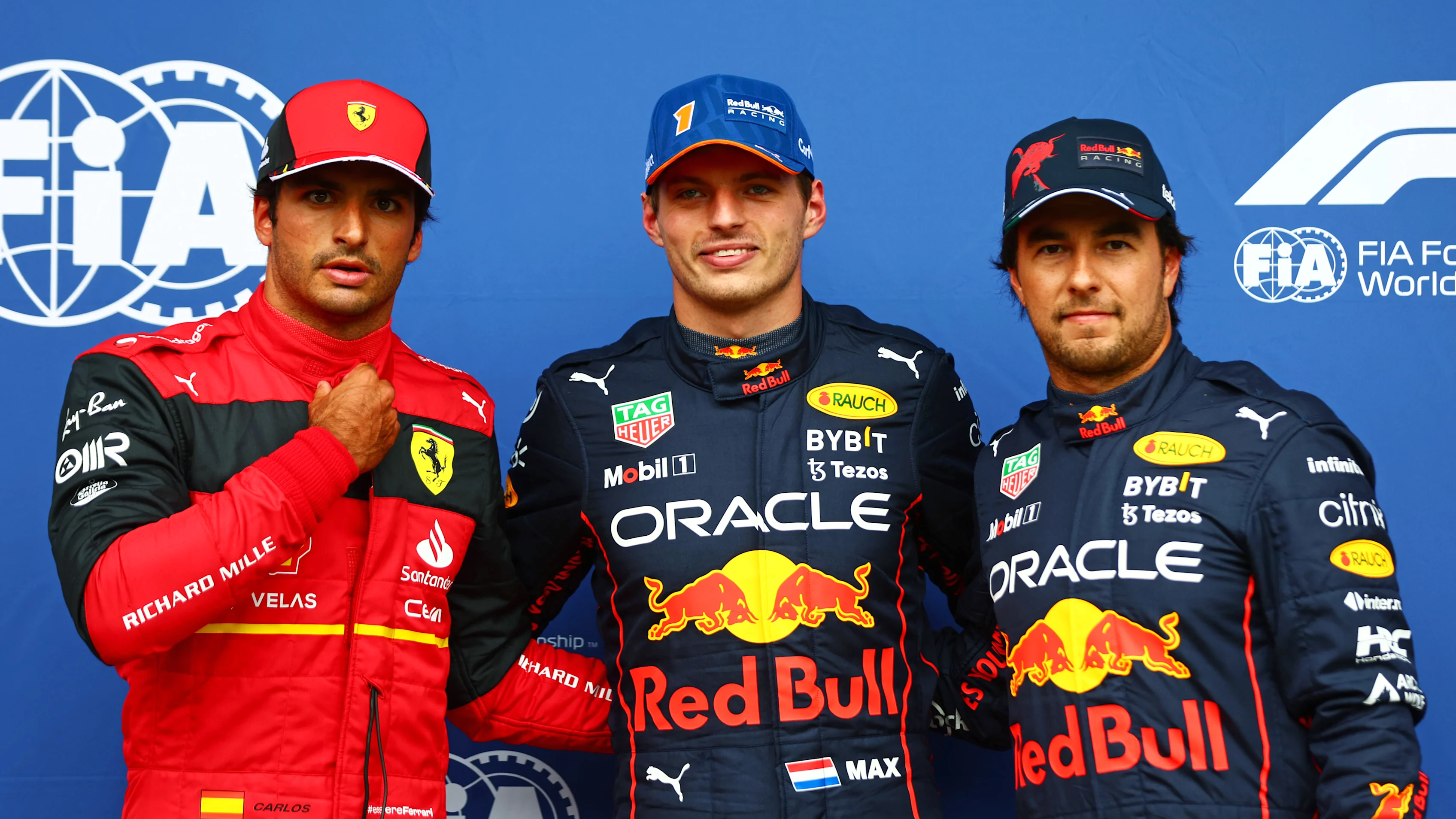 SPA, BELGIUM - AUGUST 27: Pole position qualifier Max Verstappen of the Netherlands and Oracle Red Bull Racing (C), Second placed qualifier Carlos Sainz of Spain and Ferrari (L) and Third placed qualifier Sergio Perez of Mexico and Oracle Red Bull Racing (R) pose for a photo in parc ferme during qualifying ahead of the F1 Grand Prix of Belgium at Circuit de Spa-Francorchamps on August 27, 2022 in Spa, Belgium. (Photo by Dan Istitene - Formula 1/Formula 1 via Getty Images)