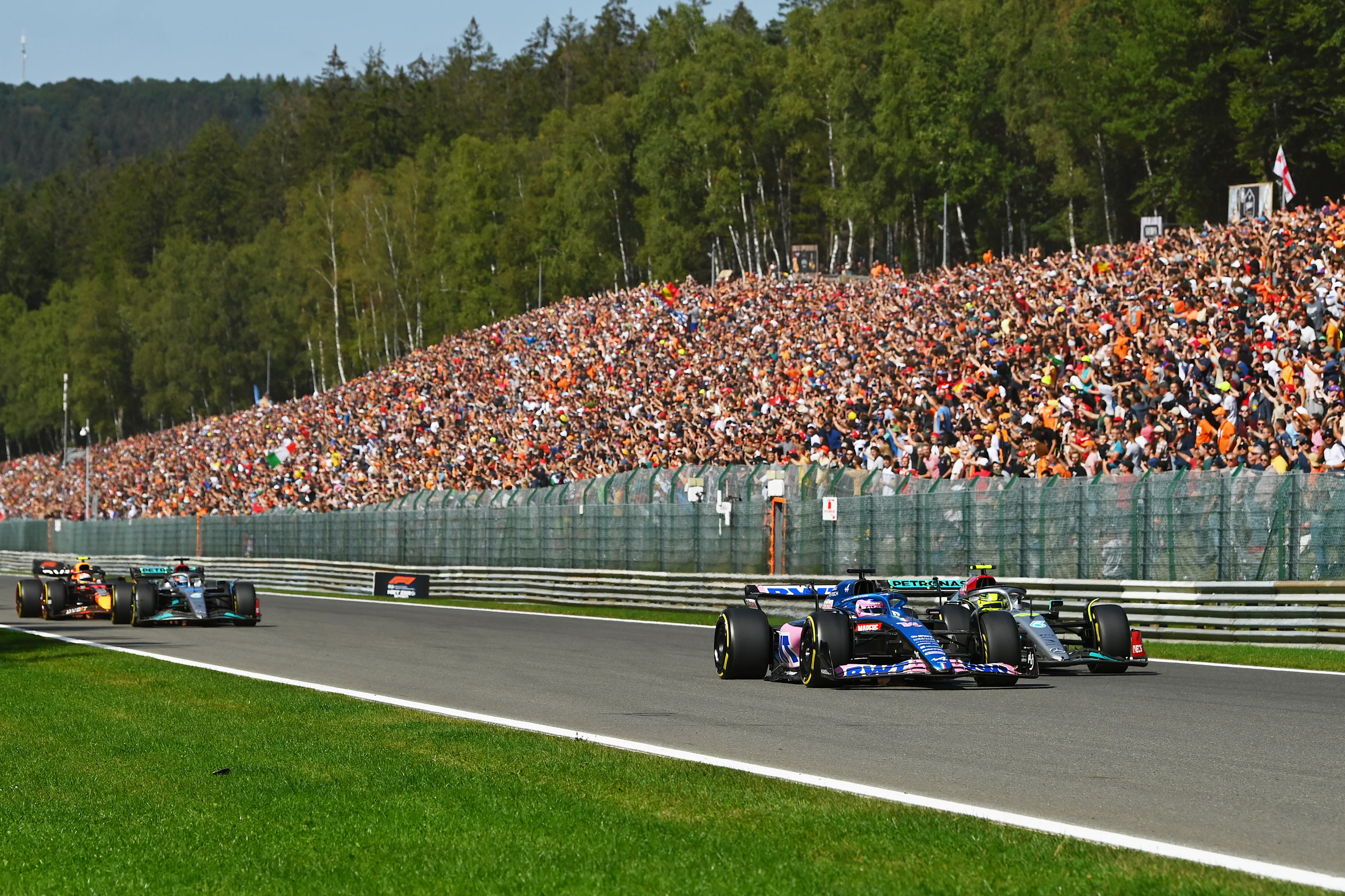 SPA, BELGIUM - AUGUST 28: Fernando Alonso of Spain driving the (14) Alpine F1 A522 Renault and Lewis Hamilton of Great Britain driving the (44) Mercedes AMG Petronas F1 Team W13 battle for track position up the Kemmel straight during the F1 Grand Prix of Belgium at Circuit de Spa-Francorchamps on August 28, 2022 in Spa, Belgium. (Photo by Dan Mullan/Getty Images)