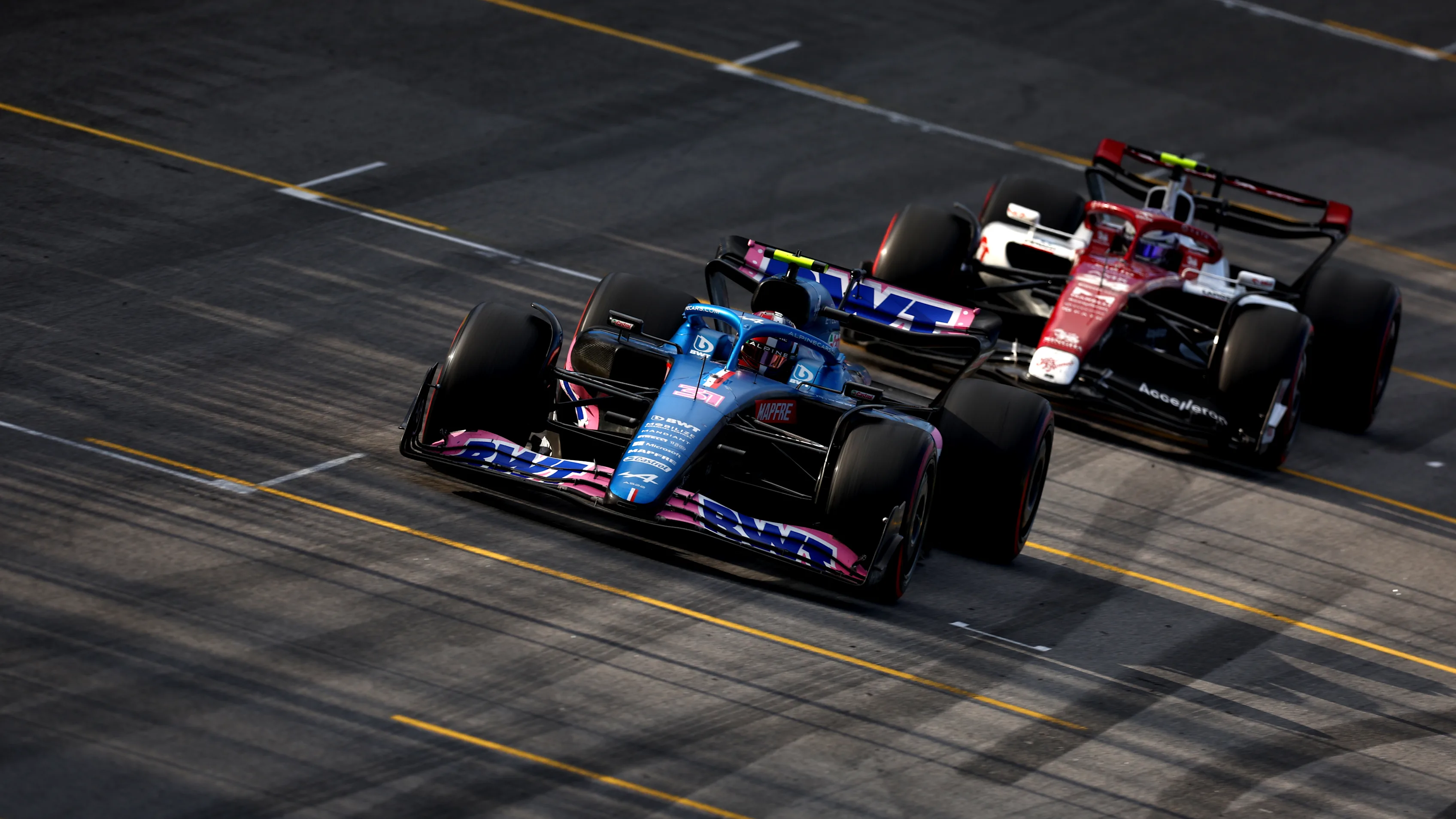 SAO PAULO, BRAZIL - NOVEMBER 12: Esteban Ocon of France driving the (31) Alpine F1 A522 Renault leads Zhou Guanyu of China driving the (24) Alfa Romeo F1 C42 Ferrari during the Sprint ahead of the F1 Grand Prix of Brazil at Autodromo Jose Carlos Pace on November 12, 2022 in Sao Paulo, Brazil. (Photo by Dan Istitene - Formula 1/Formula 1 via Getty Images)