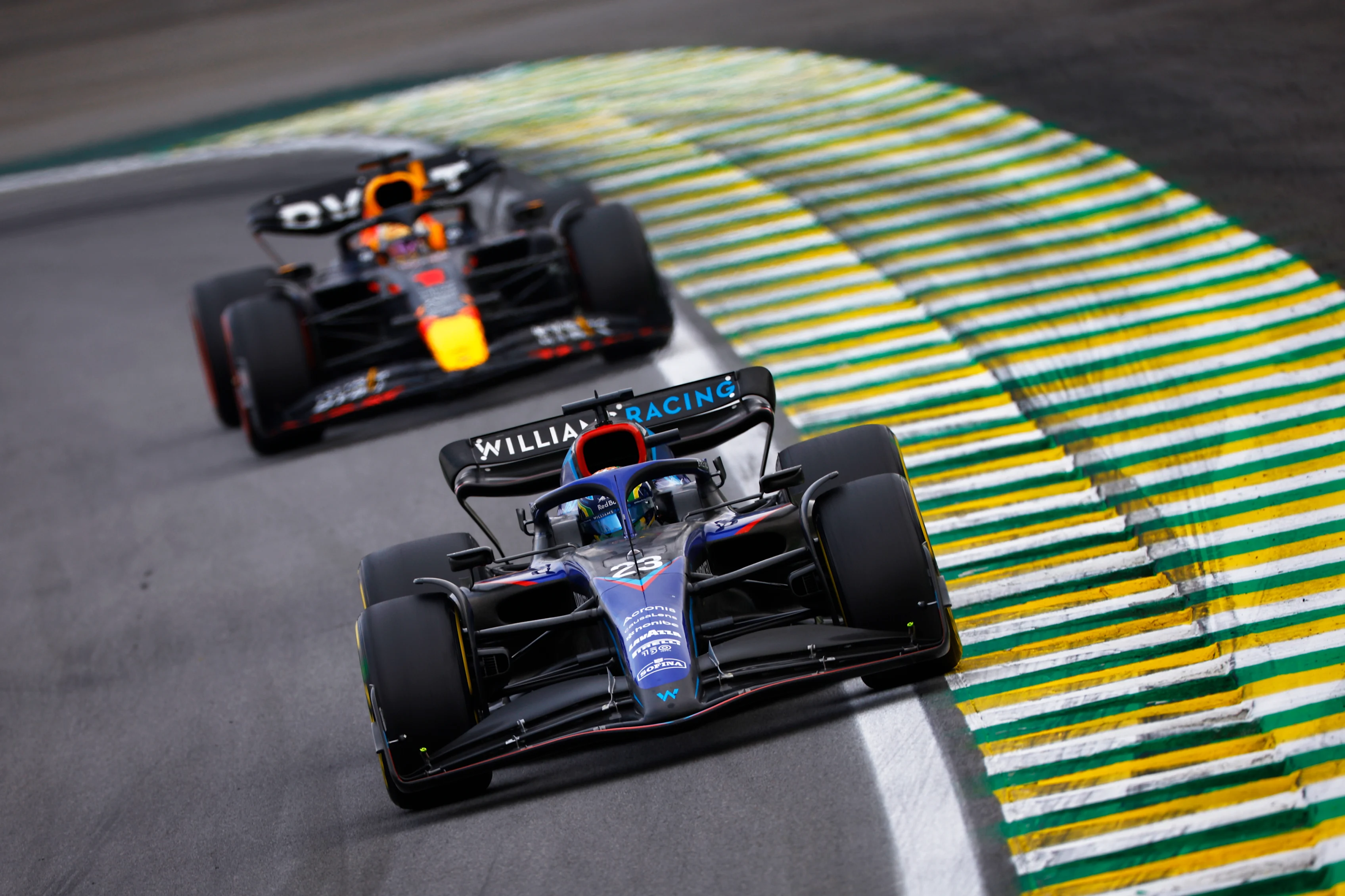 SAO PAULO, BRAZIL - NOVEMBER 13: Alexander Albon of Thailand driving the (23) Williams FW44 Mercedes leads Max Verstappen of the Netherlands driving the (1) Oracle Red Bull Racing RB18 during the F1 Grand Prix of Brazil at Autodromo Jose Carlos Pace on November 13, 2022 in Sao Paulo, Brazil. (Photo by Jared C. Tilton/Getty Images)