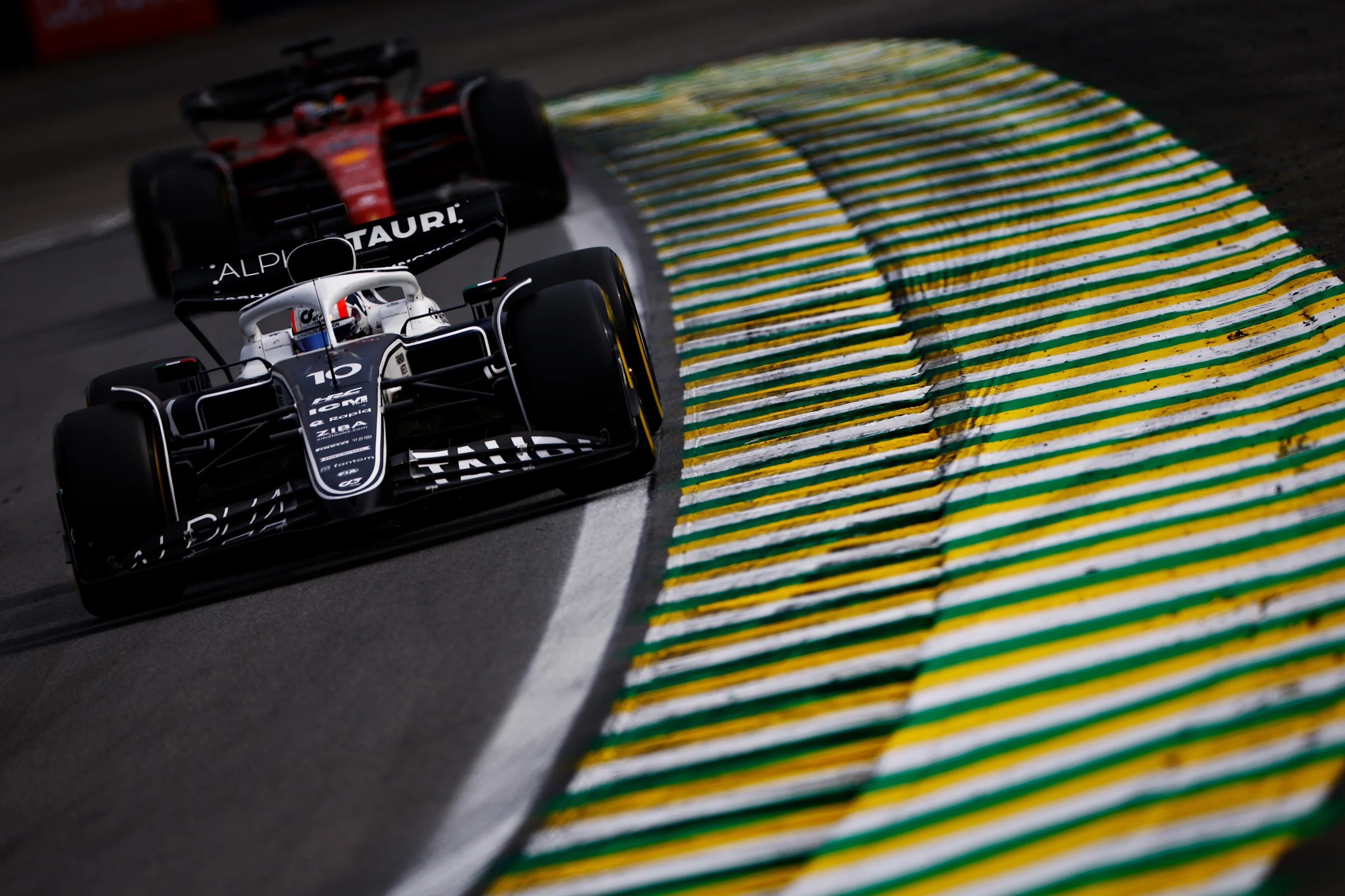 SAO PAULO, BRAZIL - NOVEMBER 13: Pierre Gasly of France driving the (10) Scuderia AlphaTauri AT03 leads Charles Leclerc of Monaco driving the (16) Ferrari F1-75 during the F1 Grand Prix of Brazil at Autodromo Jose Carlos Pace on November 13, 2022 in Sao Paulo, Brazil. (Photo by Jared C. Tilton/Getty Images)