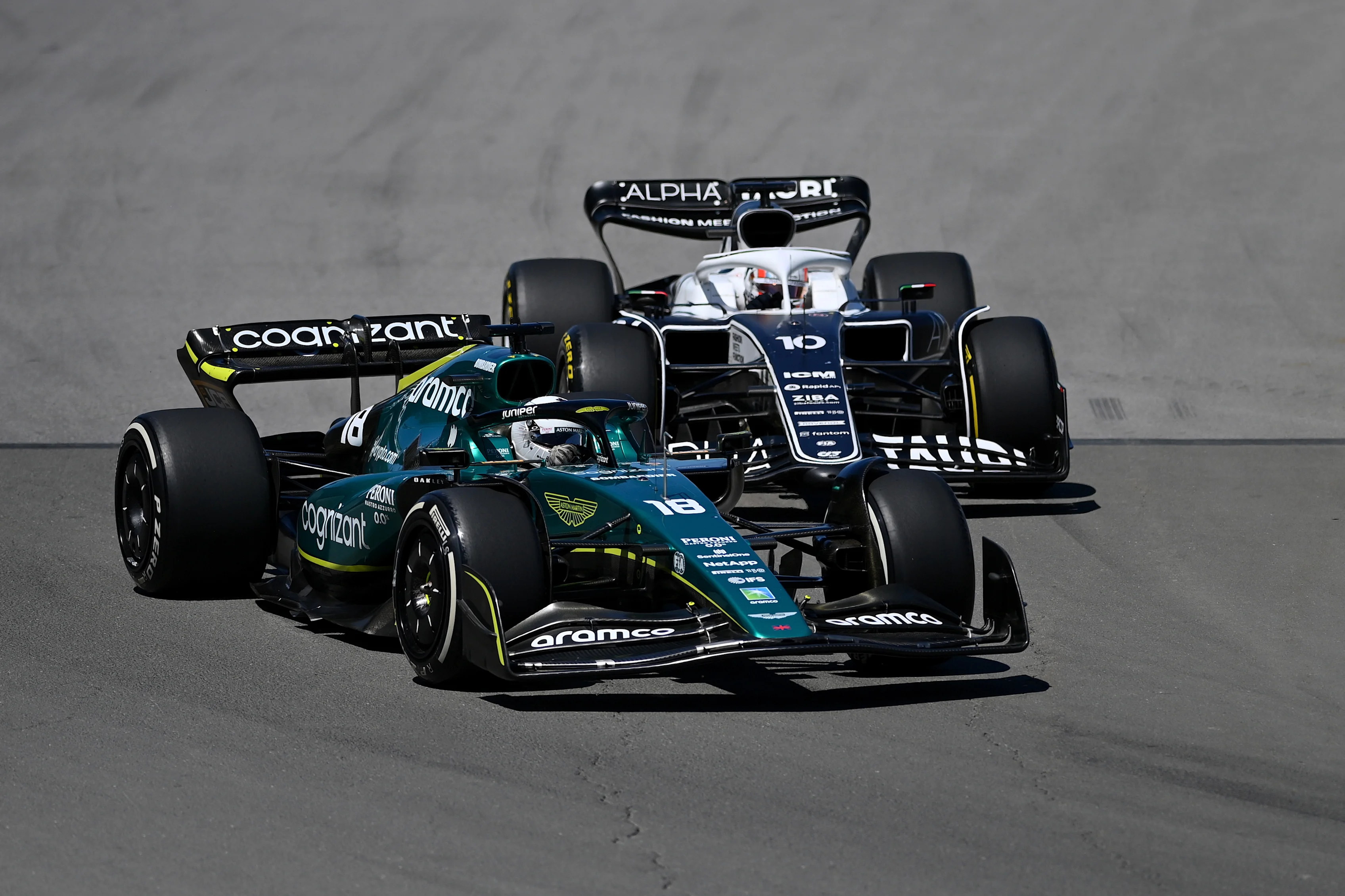 MONTREAL, QUEBEC - JUNE 19: Lance Stroll of Canada driving the (18) Aston Martin AMR22 Mercedes leads Pierre Gasly of France driving the (10) Scuderia AlphaTauri AT03 during the F1 Grand Prix of Canada at Circuit Gilles Villeneuve on June 19, 2022 in Montreal, Quebec. (Photo by Dan Mullan/Getty Images)