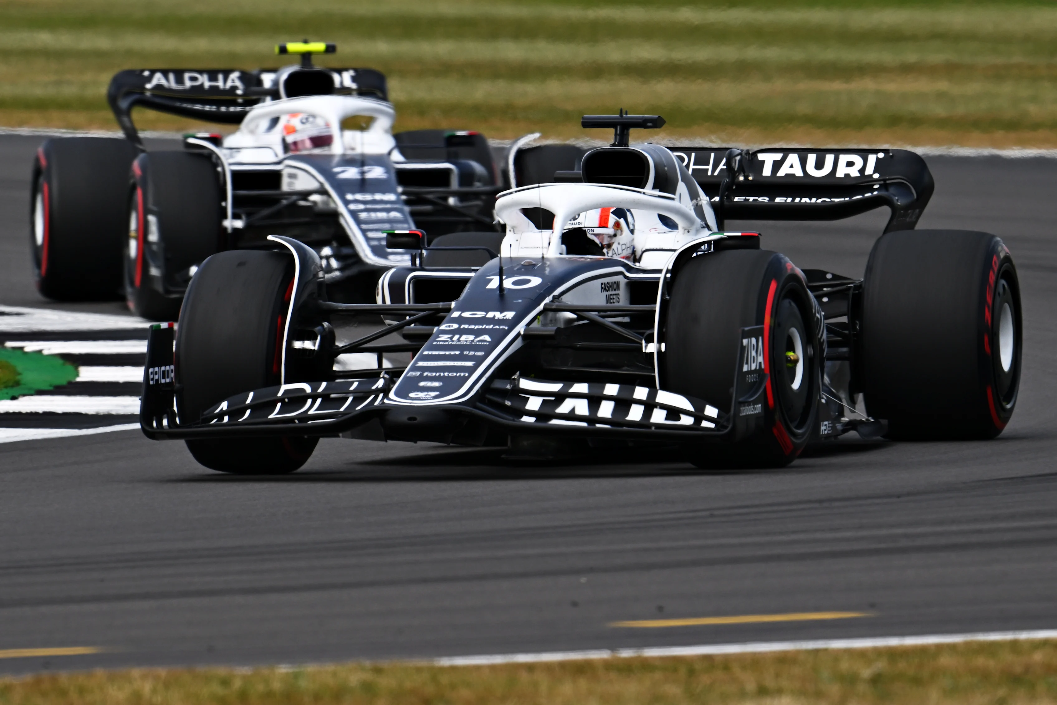 NORTHAMPTON, ENGLAND - JULY 03: Pierre Gasly of France driving the (10) Scuderia AlphaTauri AT03 leads Yuki Tsunoda of Japan driving the (22) Scuderia AlphaTauri AT03 during the F1 Grand Prix of Great Britain at Silverstone on July 03, 2022 in Northampton, England. (Photo by Clive Mason/Getty Images)