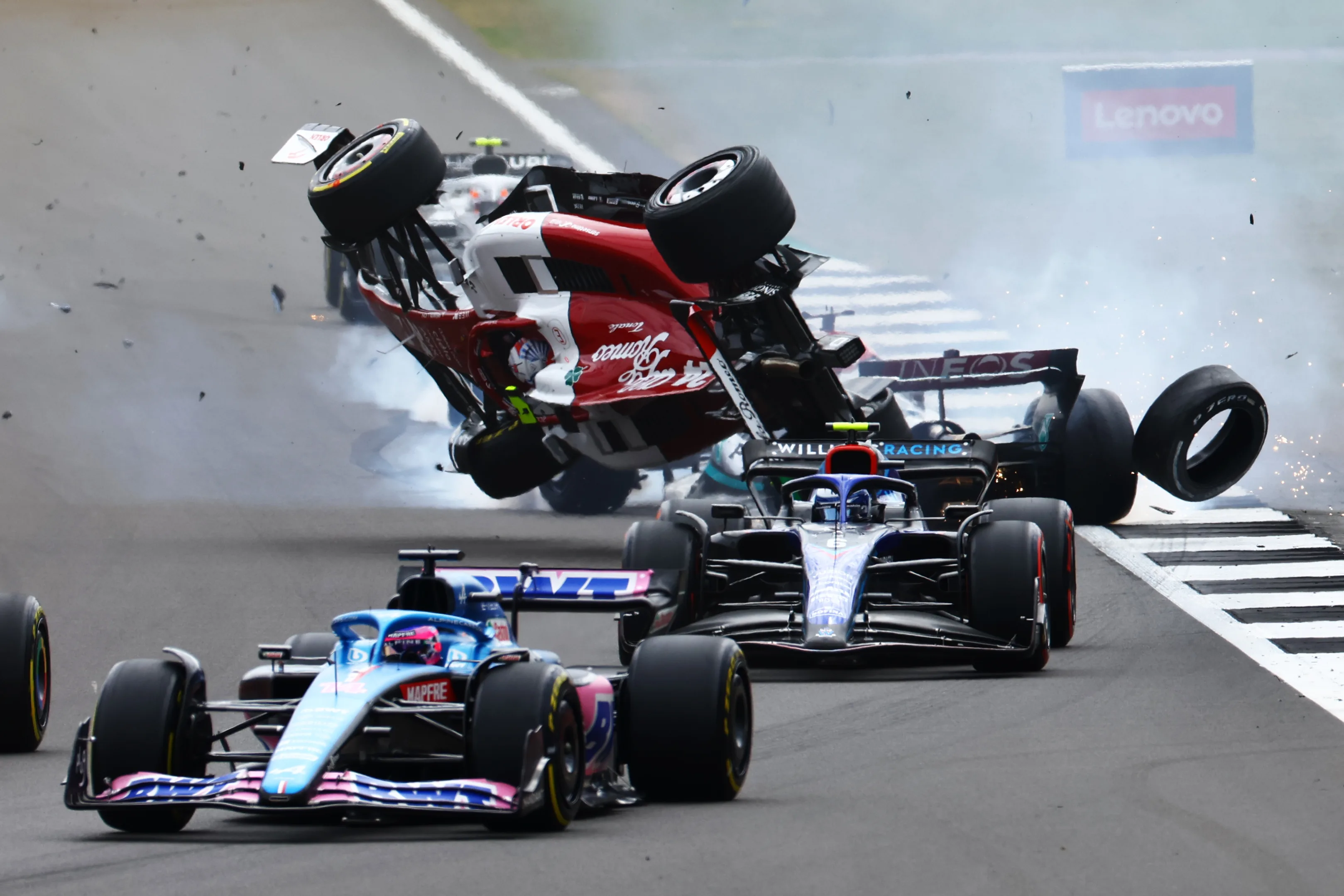 NORTHAMPTON, ENGLAND - JULY 03: Zhou Guanyu of China driving the (24) Alfa Romeo F1 C42 Ferrari crashes at the start during the F1 Grand Prix of Great Britain at Silverstone on July 03, 2022 in Northampton, England. (Photo by Mark Thompson/Getty Images)
