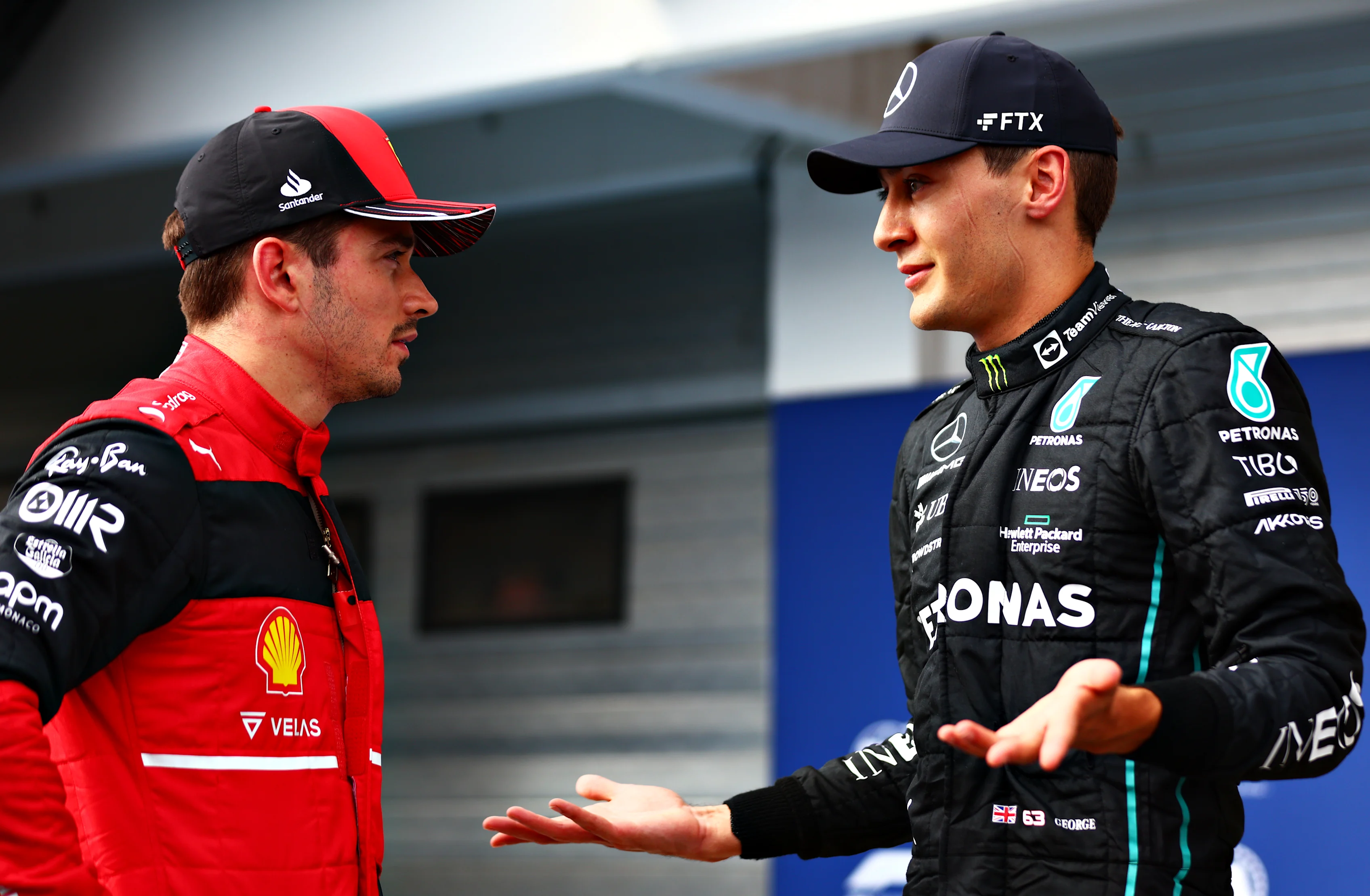 BUDAPEST, HUNGARY - JULY 30: Pole position qualifier George Russell of Great Britain and Mercedes talks with Third placed qualifier Charles Leclerc of Monaco and Ferrari in parc ferme during qualifying ahead of the F1 Grand Prix of Hungary at Hungaroring on July 30, 2022 in Budapest, Hungary. (Photo by Dan Istitene - Formula 1/Formula 1 via Getty Images)