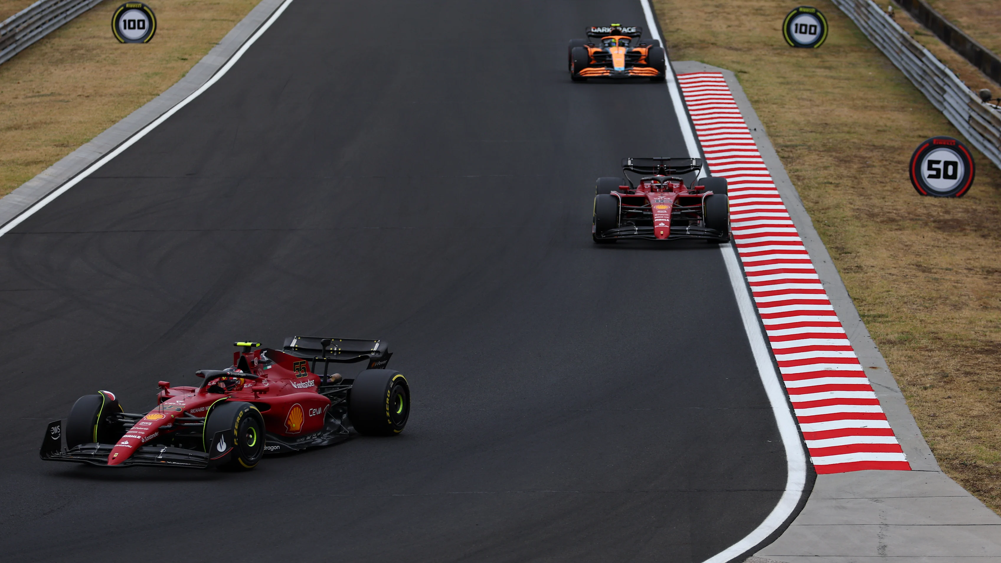 BUDAPEST, HUNGARY - JULY 31: Carlos Sainz of Spain driving (55) the Ferrari F1-75 leads Charles Leclerc of Monaco driving the (16) Ferrari F1-75 during the F1 Grand Prix of Hungary at Hungaroring on July 31, 2022 in Budapest, Hungary. (Photo by Bryn Lennon - Formula 1/Formula 1 via Getty Images)