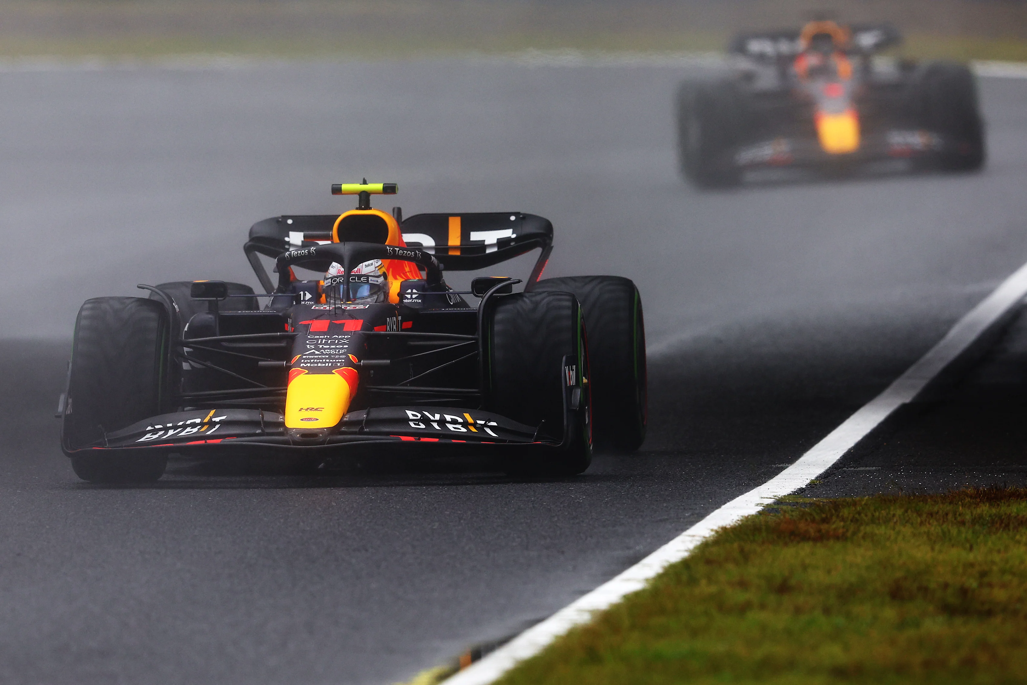 SUZUKA, JAPAN - OCTOBER 07: Sergio Perez of Mexico driving the (11) Oracle Red Bull Racing RB18 leads Max Verstappen of the Netherlands driving the (1) Oracle Red Bull Racing RB18 during practice ahead of the F1 Grand Prix of Japan at Suzuka International Racing Course on October 07, 2022 in Suzuka, Japan. (Photo by Clive Rose/Getty Images)