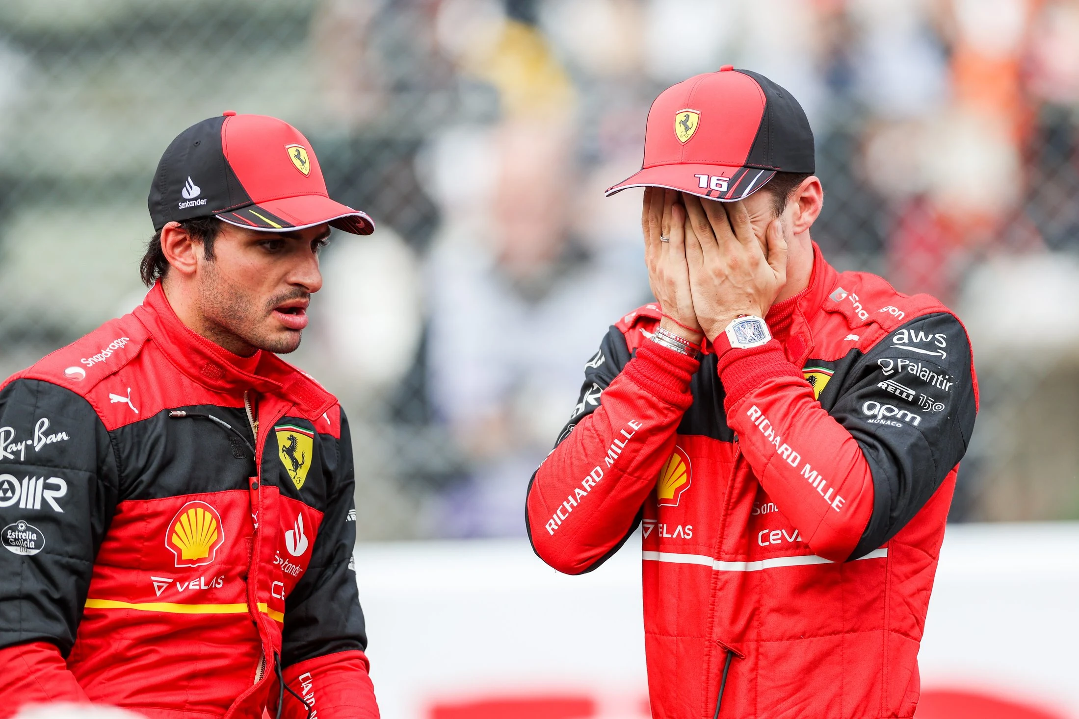 SUZUKA, JAPAN - OCTOBER 08: Carlos Sainz of Ferrari and Spain chats with Charles Leclerc of Ferrari and Monaco during qualifying ahead of the F1 Grand Prix of Japan at Suzuka International Racing Course on October 08, 2022 in Suzuka, Japan. (Photo by Peter Fox/Getty Images )