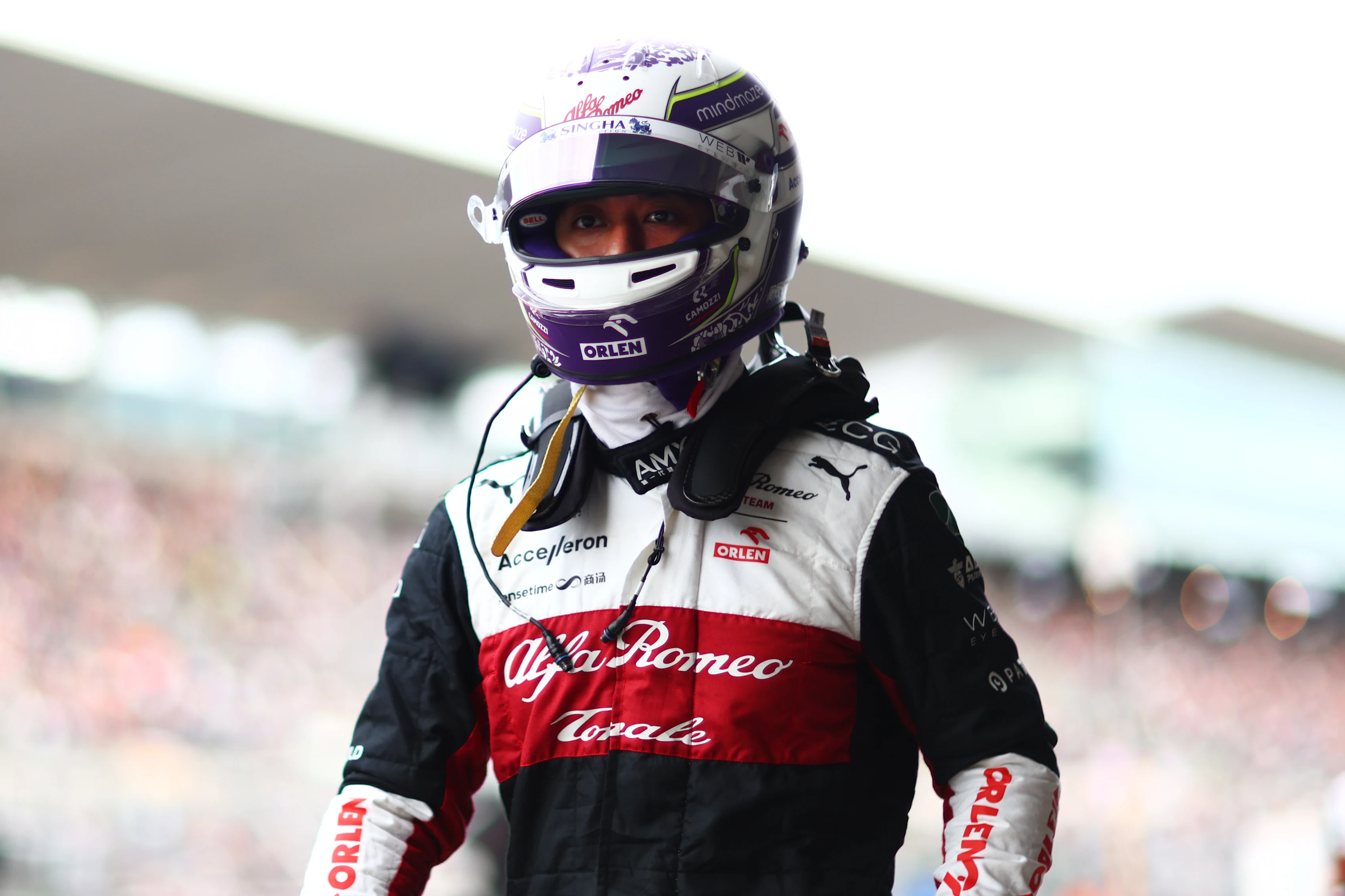 SUZUKA, JAPAN - OCTOBER 08: Fourteenth placed qualifier Zhou Guanyu of China and Alfa Romeo F1 walks in the Pitlane during qualifying ahead of the F1 Grand Prix of Japan at Suzuka International Racing Course on October 08, 2022 in Suzuka, Japan. (Photo by Dan Istitene - Formula 1/Formula 1 via Getty Images)