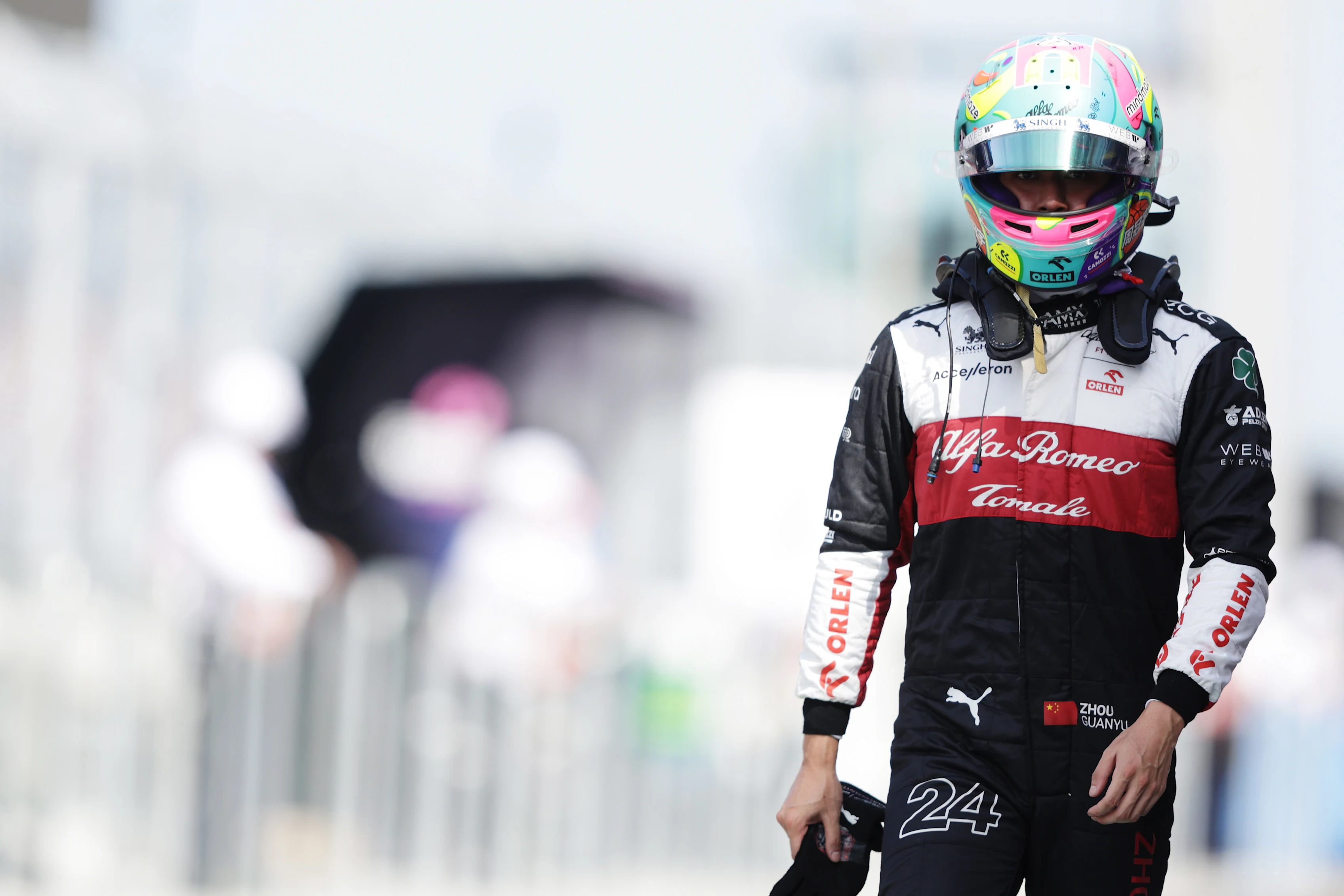 MIAMI, FLORIDA - MAY 07: 17th placed qualifier Zhou Guanyu of China and Alfa Romeo F1 walks in the Pitlane during qualifying ahead of the F1 Grand Prix of Miami at the Miami International Autodrome on May 07, 2022 in Miami, Florida. (Photo by Mark Thompson/Getty Images)