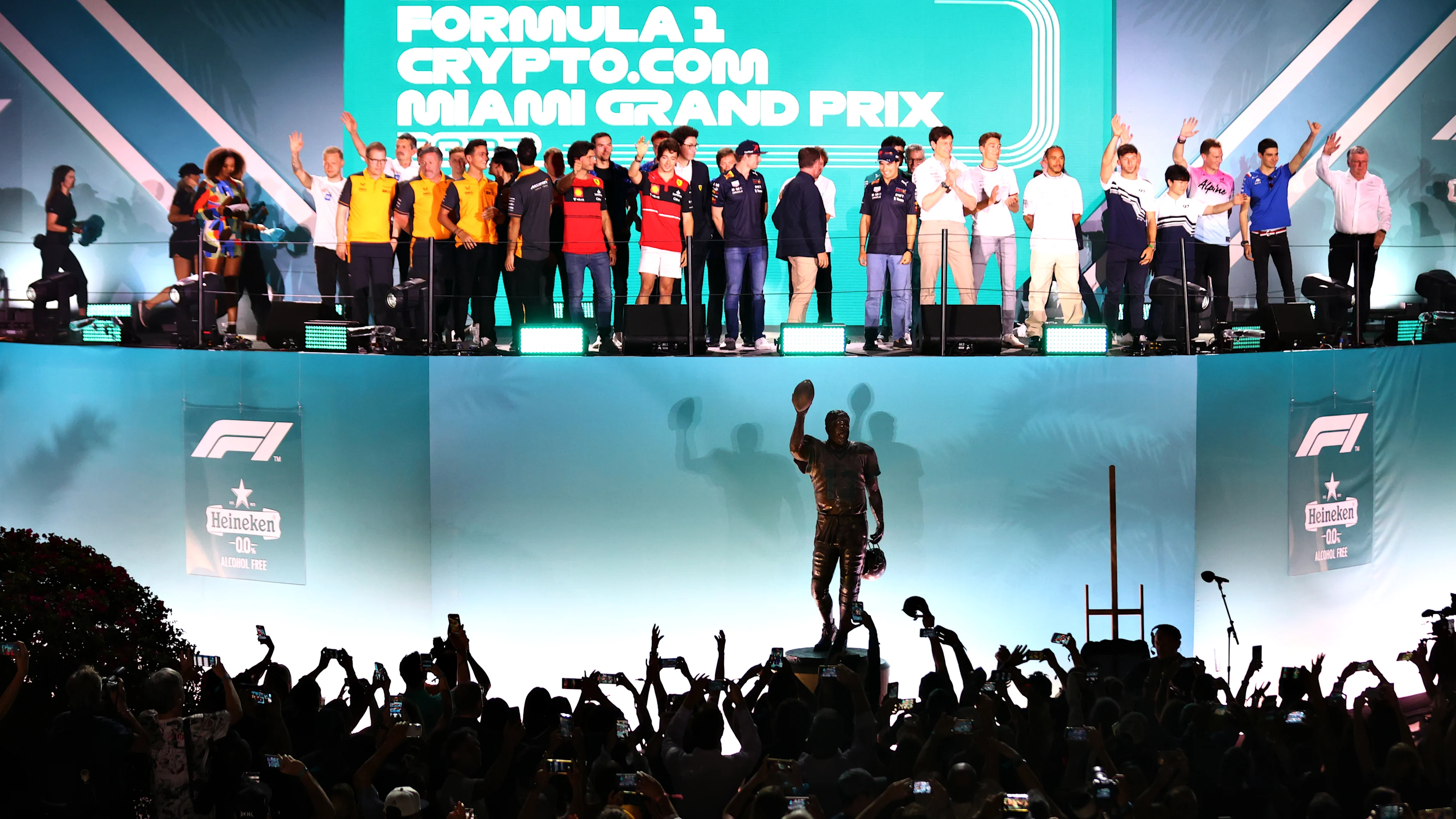 MIAMI GARDENS, FLORIDA - MAY 04: The F1 drivers throw out gifts to the crowd from the stage during