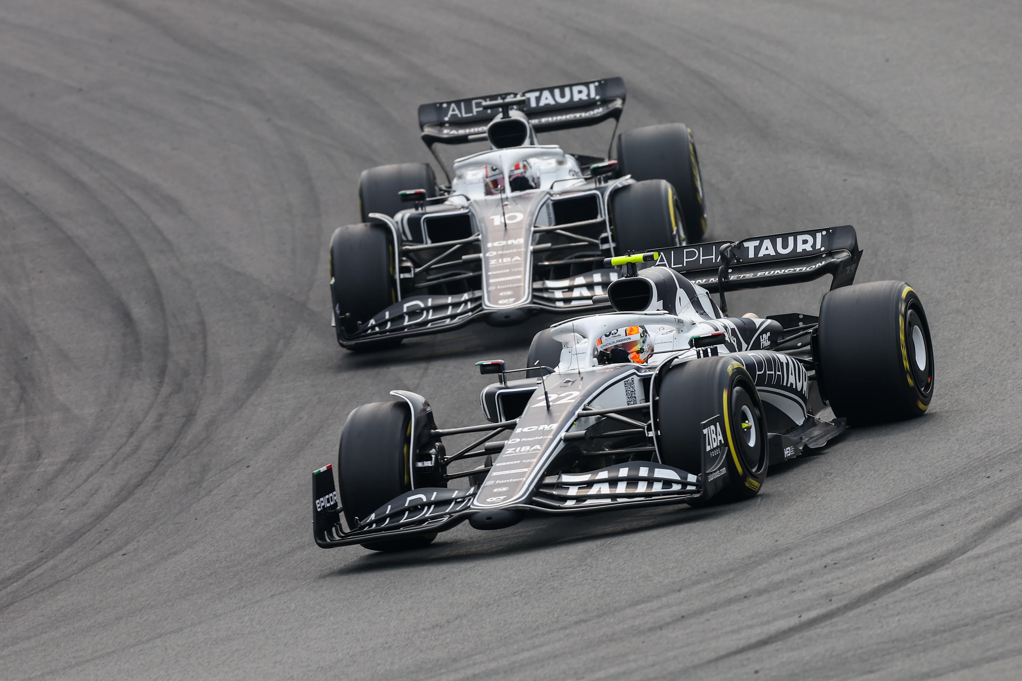 ZANDVOORT, NETHERLANDS - SEPTEMBER 04: Yuki Tsunoda of Scuderia AlphaTauri and Japan leads Pierre Gasly of Scuderia AlphaTauri and France  during the F1 Grand Prix of The Netherlands at Circuit Zandvoort on September 04, 2022 in Zandvoort, Netherlands. (Photo by Peter Fox/Getty Images)