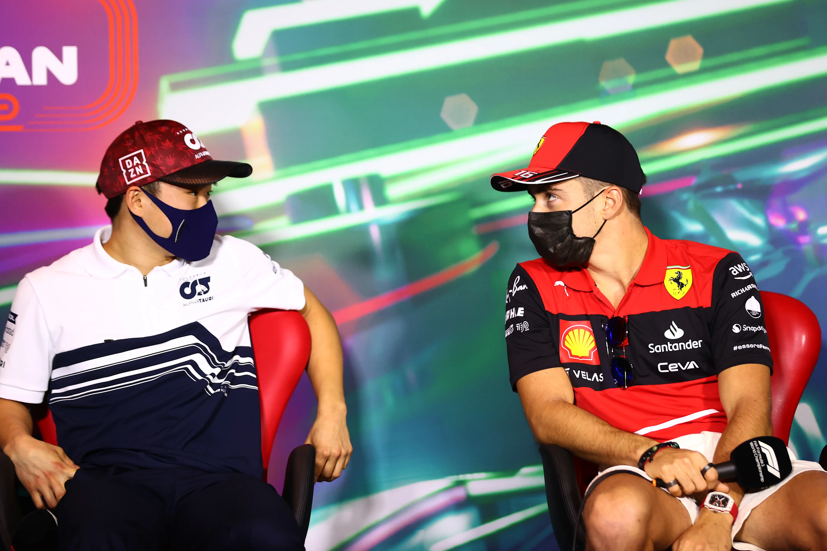 JEDDAH, SAUDI ARABIA - MARCH 25: Yuki Tsunoda of Japan and Scuderia AlphaTauri and Charles Leclerc of Monaco and Ferrari talk in the Drivers Press Conference before practice ahead of the F1 Grand Prix of Saudi Arabia at the Jeddah Corniche Circuit on March 25, 2022 in Jeddah, Saudi Arabia. (Photo by Dan Istitene - Formula 1/Formula 1 via Getty Images)