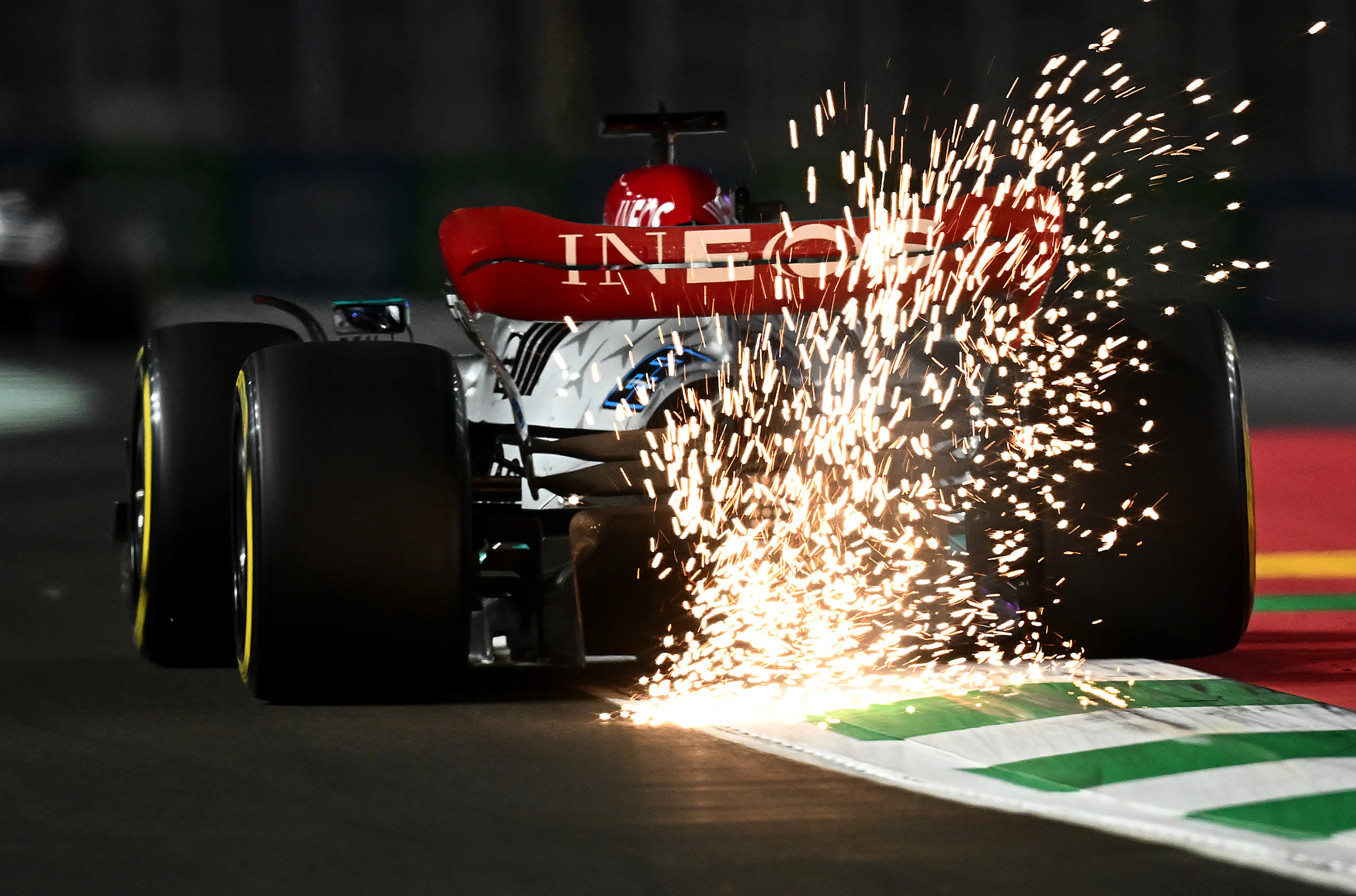 JEDDAH, SAUDI ARABIA - MARCH 25: Sparks fly behind George Russell of Great Britain driving the (63) Mercedes AMG Petronas F1 Team W13 on track during practice ahead of the F1 Grand Prix of Saudi Arabia at the Jeddah Corniche Circuit on March 25, 2022 in Jeddah, Saudi Arabia. (Photo by Clive Mason/Getty Images)