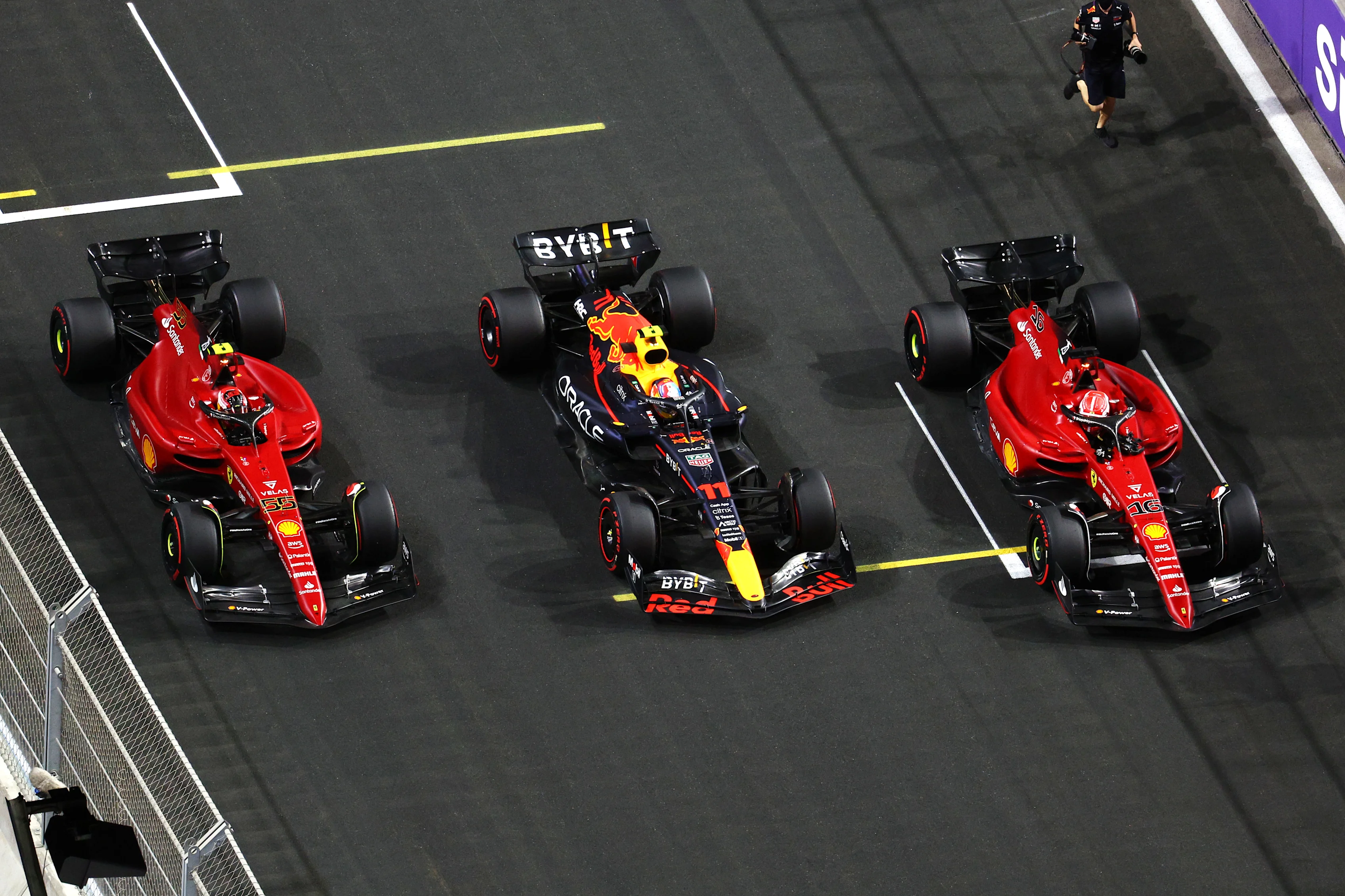 JEDDAH, SAUDI ARABIA - MARCH 26: Pole position qualifier Sergio Perez of Mexico and Oracle Red Bull Racing, Second placed qualifier Charles Leclerc of Monaco and Ferrari and Third placed qualifier Carlos Sainz of Spain and Ferrari stop in parc ferme during qualifying ahead of the F1 Grand Prix of Saudi Arabia at the Jeddah Corniche Circuit on March 26, 2022 in Jeddah, Saudi Arabia. (Photo by Clive Rose - Formula 1/Formula 1 via Getty Images)