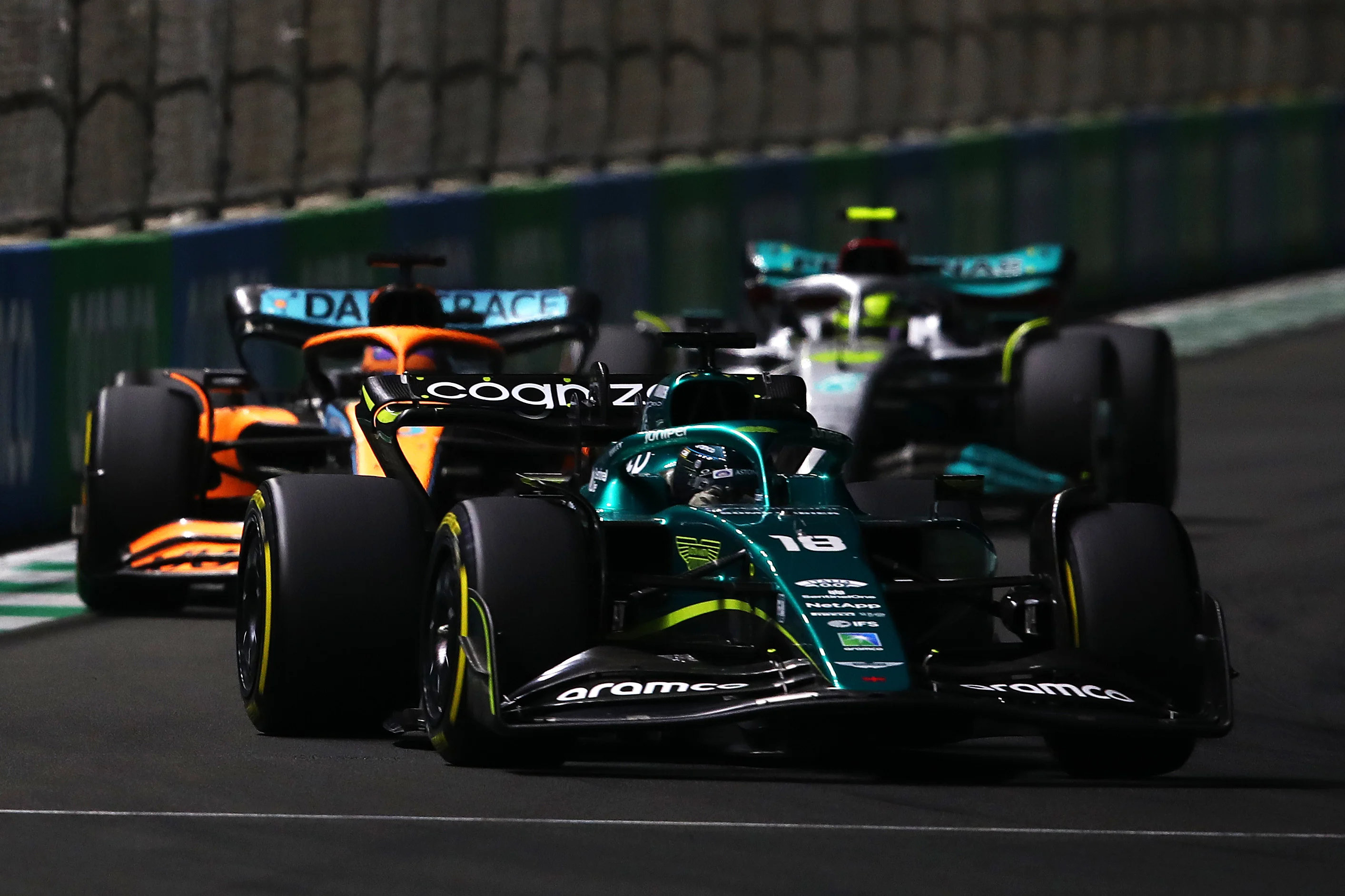JEDDAH, SAUDI ARABIA - MARCH 27: Lance Stroll of Canada driving the (18) Aston Martin AMR22 Mercedes leads Daniel Ricciardo of Australia driving the (3) McLaren MCL36 Mercedes  during the F1 Grand Prix of Saudi Arabia at the Jeddah Corniche Circuit on March 27, 2022 in Jeddah, Saudi Arabia. (Photo by Joe Portlock - Formula 1/Formula 1 via Getty Images)