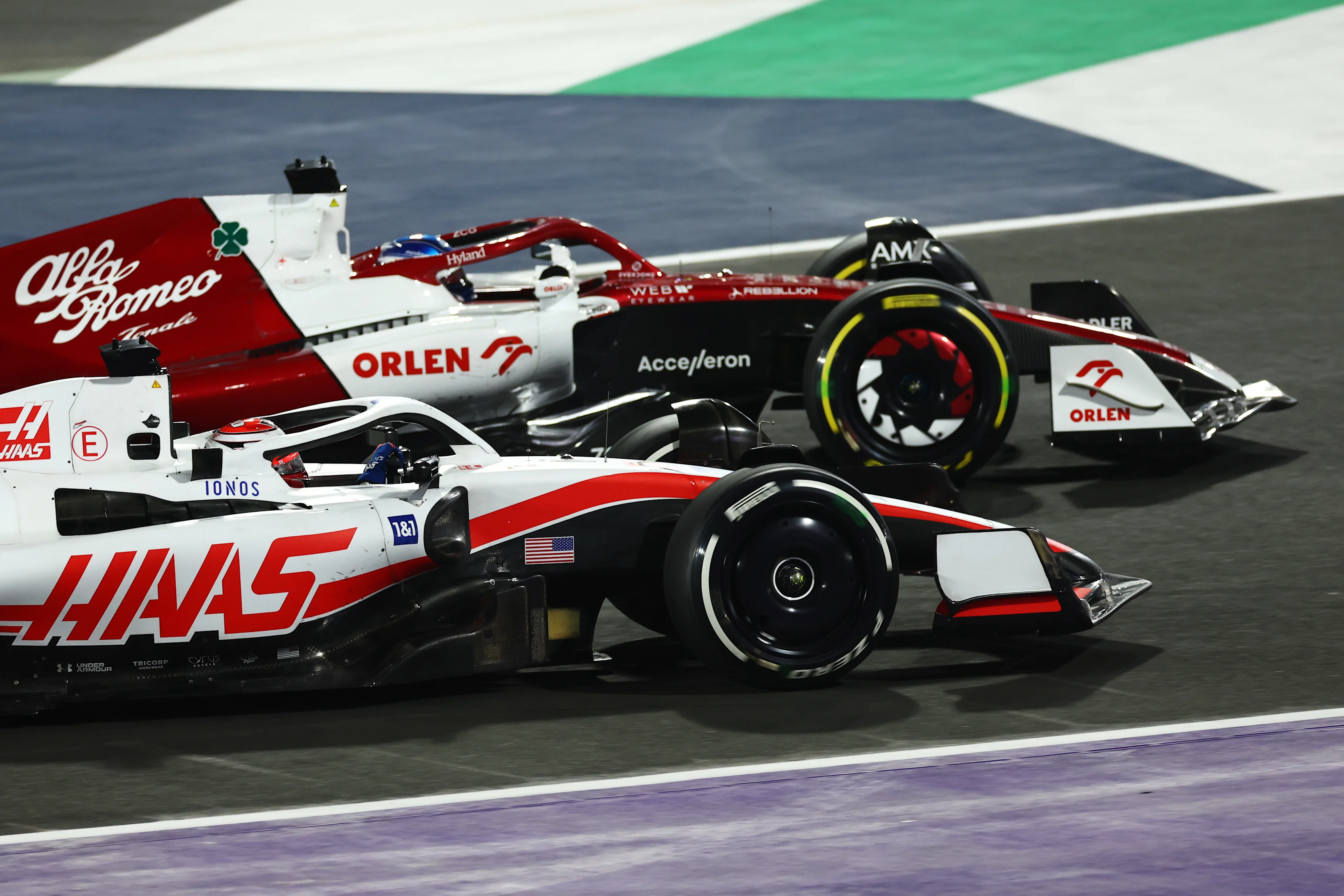 JEDDAH, SAUDI ARABIA - MARCH 27: Valtteri Bottas of Finland driving the (77) Alfa Romeo F1 C42 Ferrari and Kevin Magnussen of Denmark driving the (20) Haas F1 VF-22 Ferrari battle for track position during the F1 Grand Prix of Saudi Arabia at the Jeddah Corniche Circuit on March 27, 2022 in Jeddah, Saudi Arabia. (Photo by Lars Baron/Getty Images)