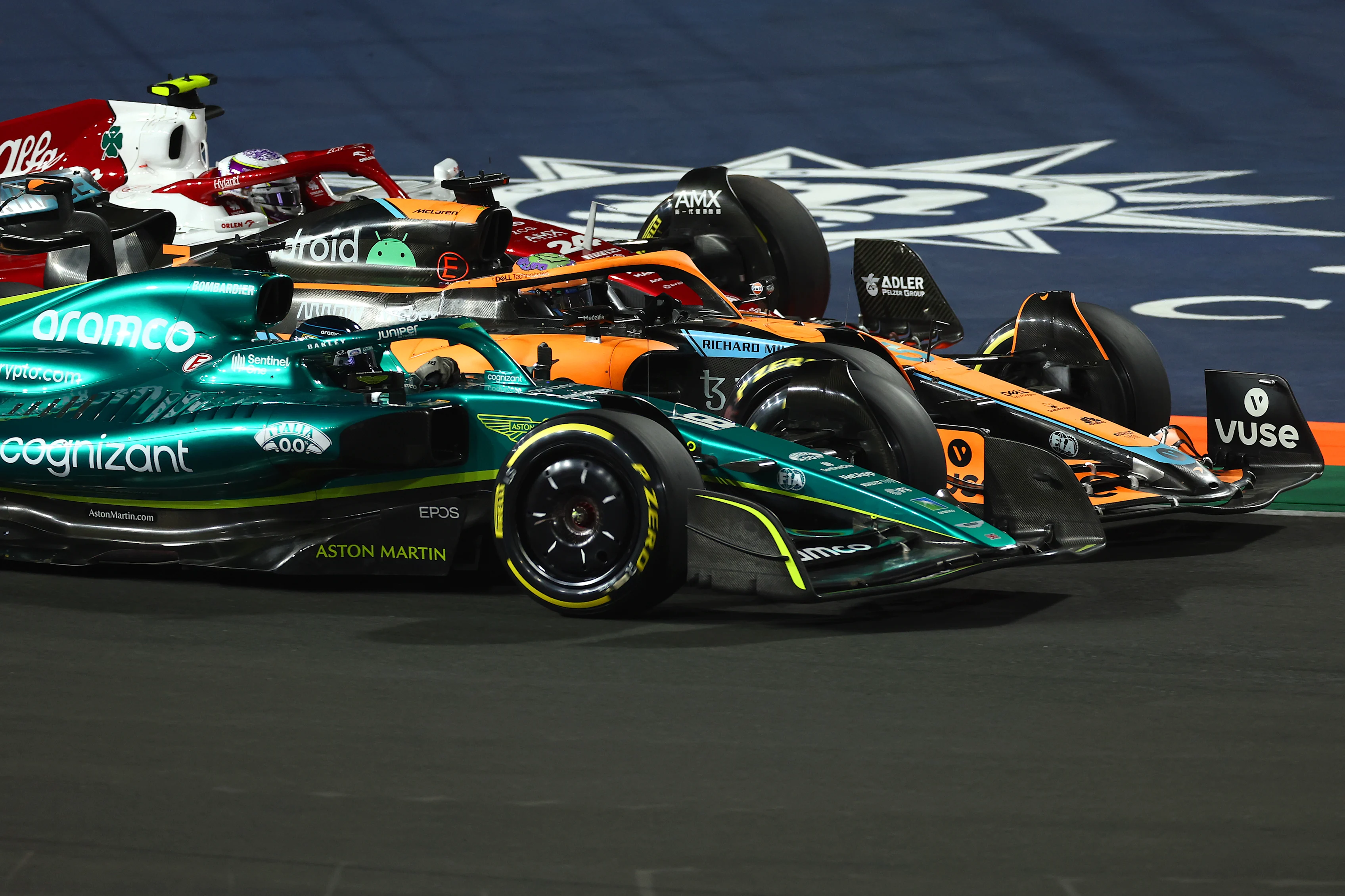 JEDDAH, SAUDI ARABIA - MARCH 27: Lance Stroll of Canada driving the (18) Aston Martin AMR22 Mercedes Daniel Ricciardo of Australia driving the (3) McLaren MCL36 Mercedes and Zhou Guanyu of China driving the (24) Alfa Romeo F1 C42 Ferrari on track during the F1 Grand Prix of Saudi Arabia at the Jeddah Corniche Circuit on March 27, 2022 in Jeddah, Saudi Arabia. (Photo by Lars Baron/Getty Images)