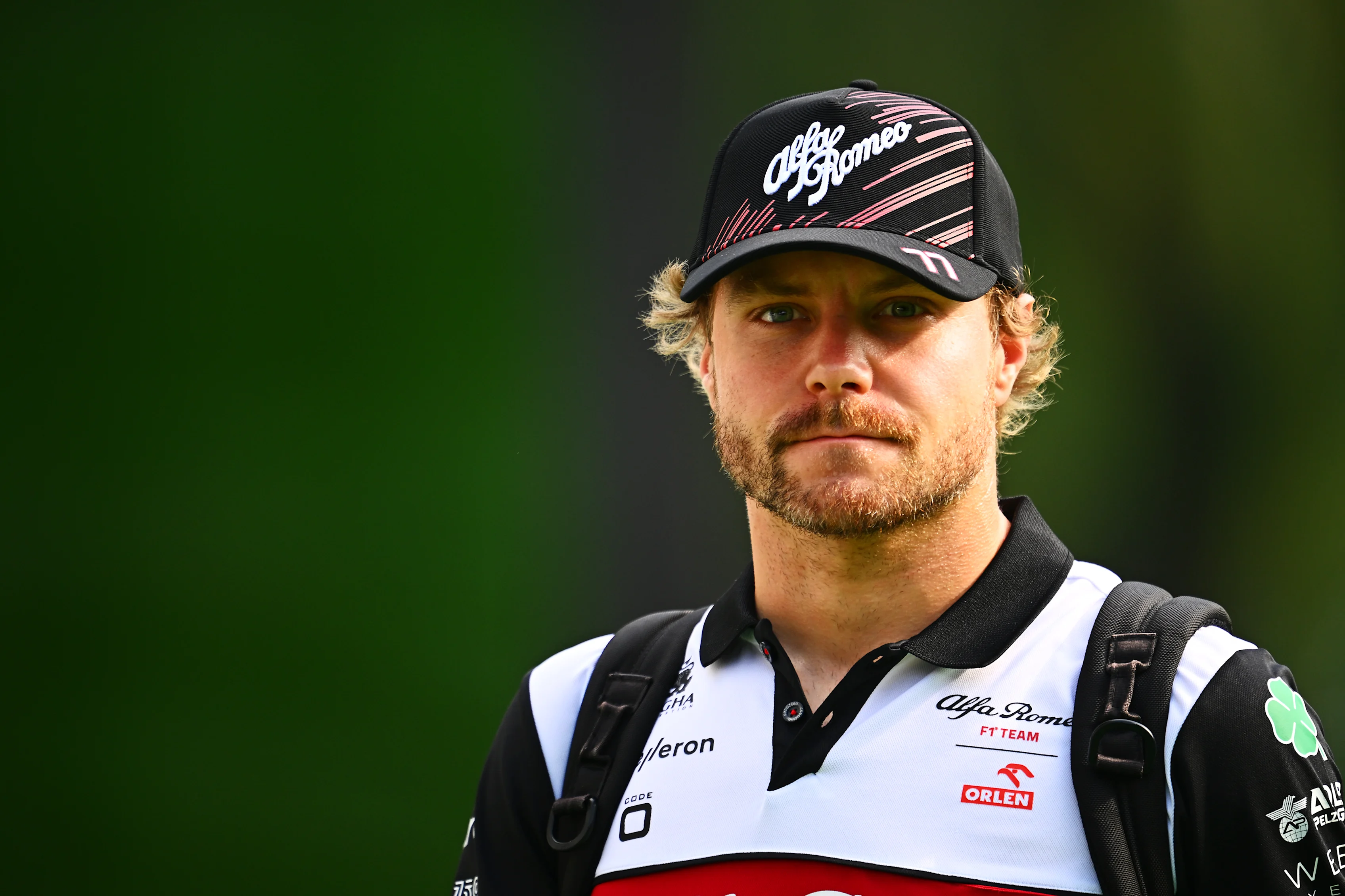 SINGAPORE, SINGAPORE - SEPTEMBER 30: Valtteri Bottas of Finland and Alfa Romeo F1 walks in the Paddock prior to practice ahead of the F1 Grand Prix of Singapore at Marina Bay Street Circuit on September 30, 2022 in Singapore, Singapore. (Photo by Clive Mason/Getty Images,)