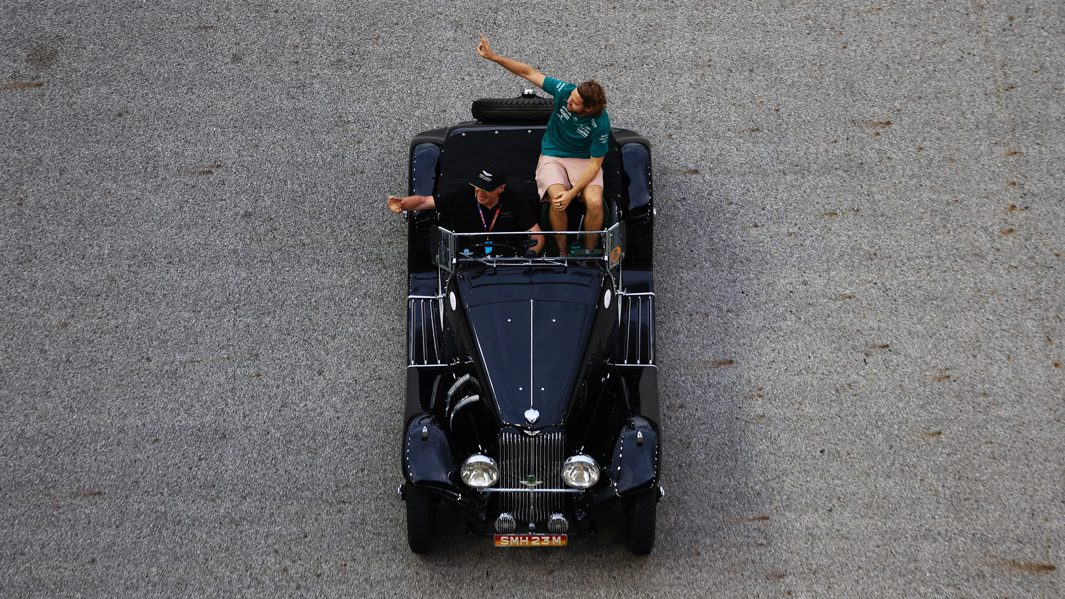 SINGAPORE, SINGAPORE - OCTOBER 02: Sebastian Vettel of Germany and Aston Martin F1 Team waves to the crowd on the drivers parade prior to the F1 Grand Prix of Singapore at Marina Bay Street Circuit on October 02, 2022 in Singapore, Singapore. (Photo by Bryn Lennon - Formula 1/Formula 1 via Getty Images)