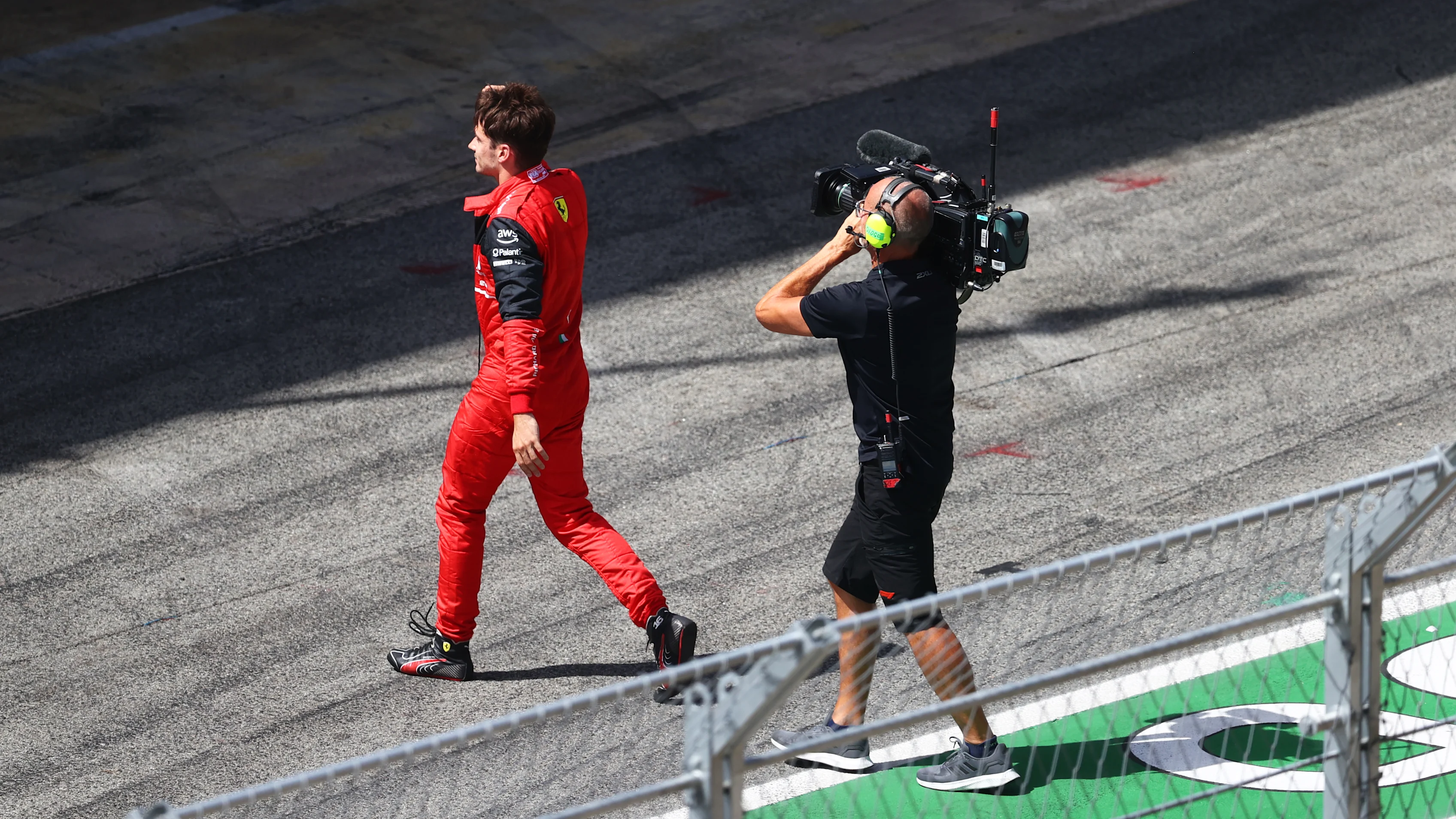 BARCELONA, SPAIN - MAY 22: Charles Leclerc of Monaco and Ferrari walks in the Pitlane after