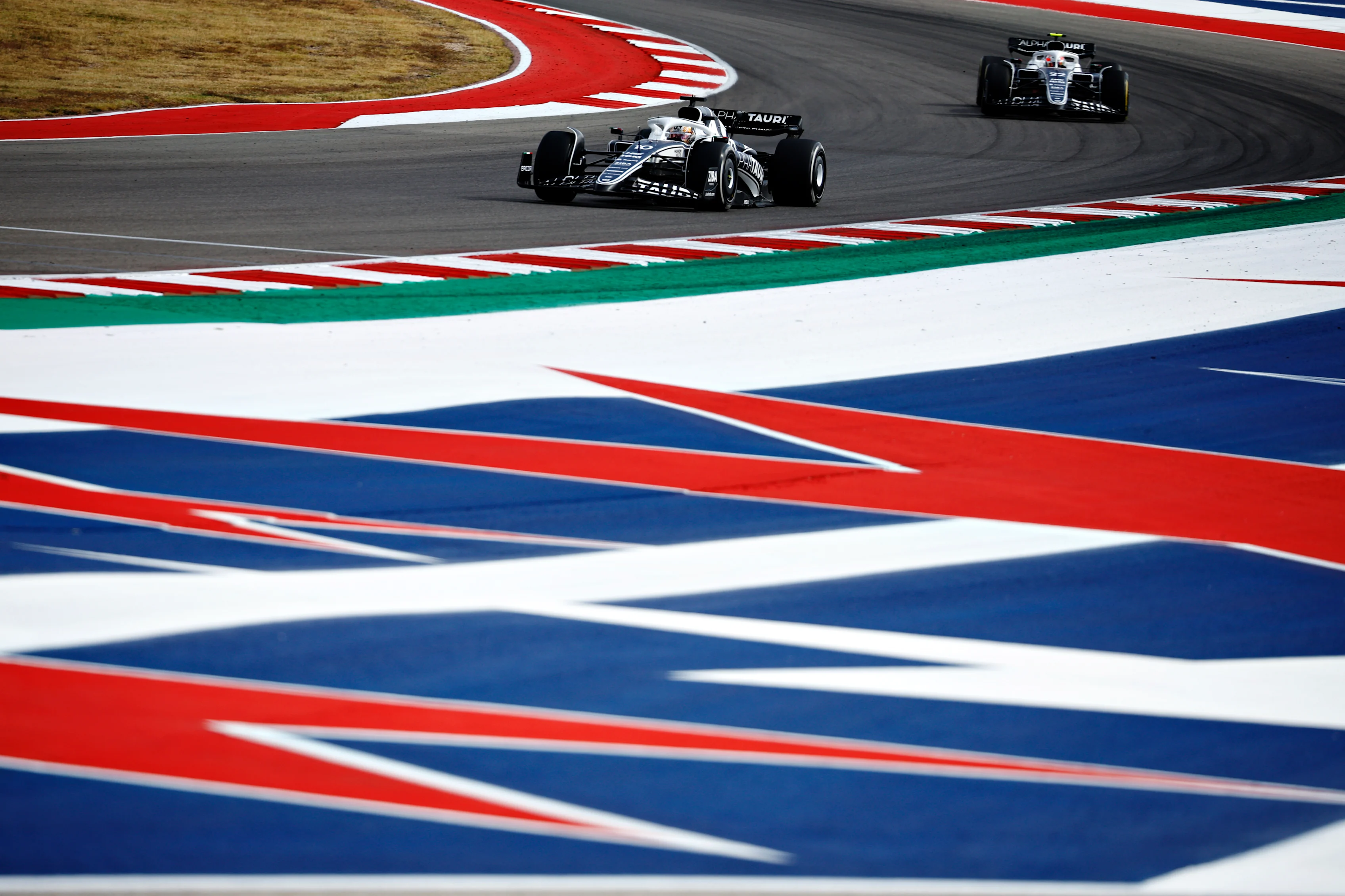 AUSTIN, TEXAS - OCTOBER 23: Pierre Gasly of France driving the (10) Scuderia AlphaTauri AT03 leads Yuki Tsunoda of Japan driving the (22) Scuderia AlphaTauri AT03 during the F1 Grand Prix of USA at Circuit of The Americas on October 23, 2022 in Austin, Texas. (Photo by Chris Graythen/Getty Images)