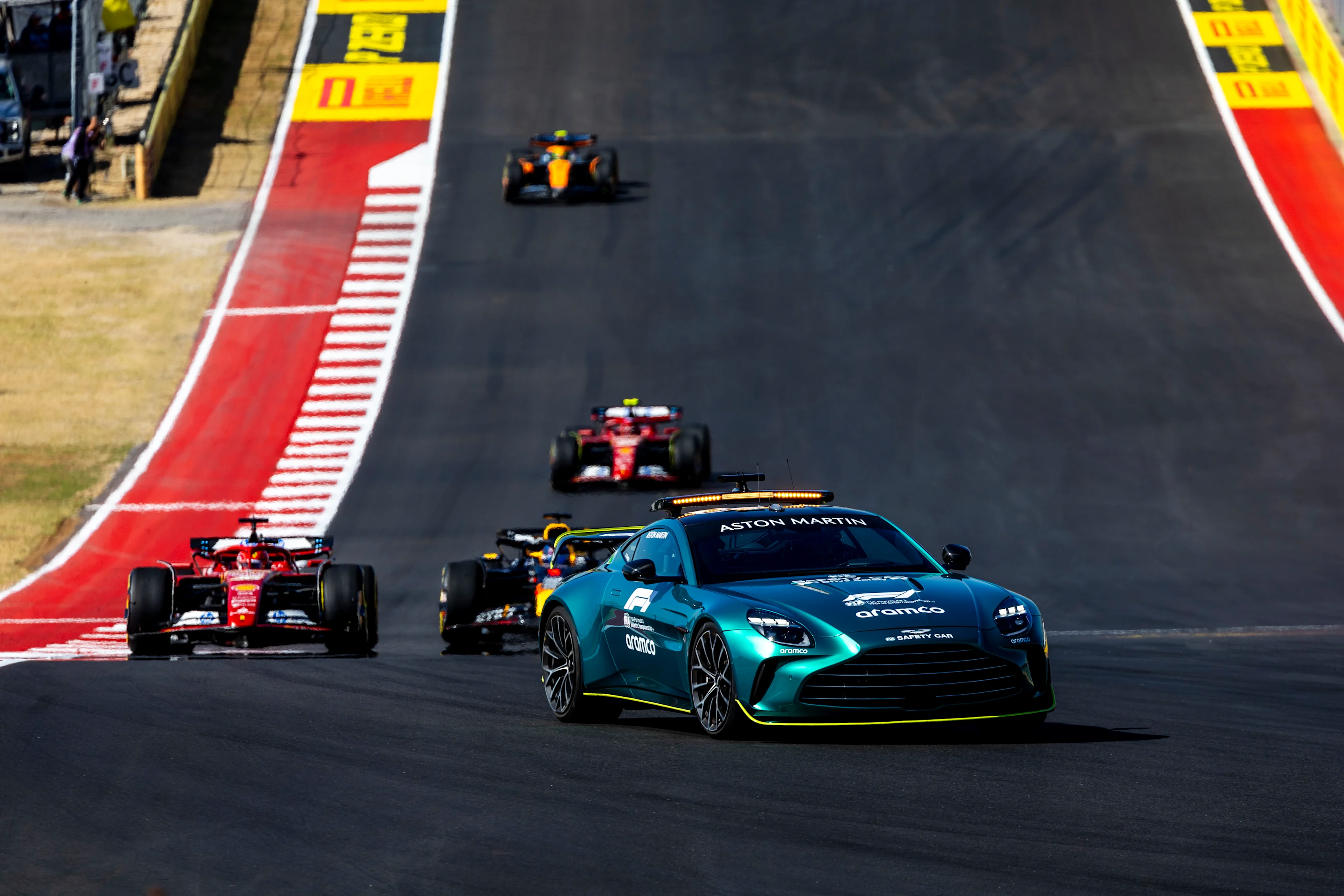 The Aston Martin Vantage Safety Car leads Charles Leclerc, Ferrari SF-24, Max Verstappen, Red Bull