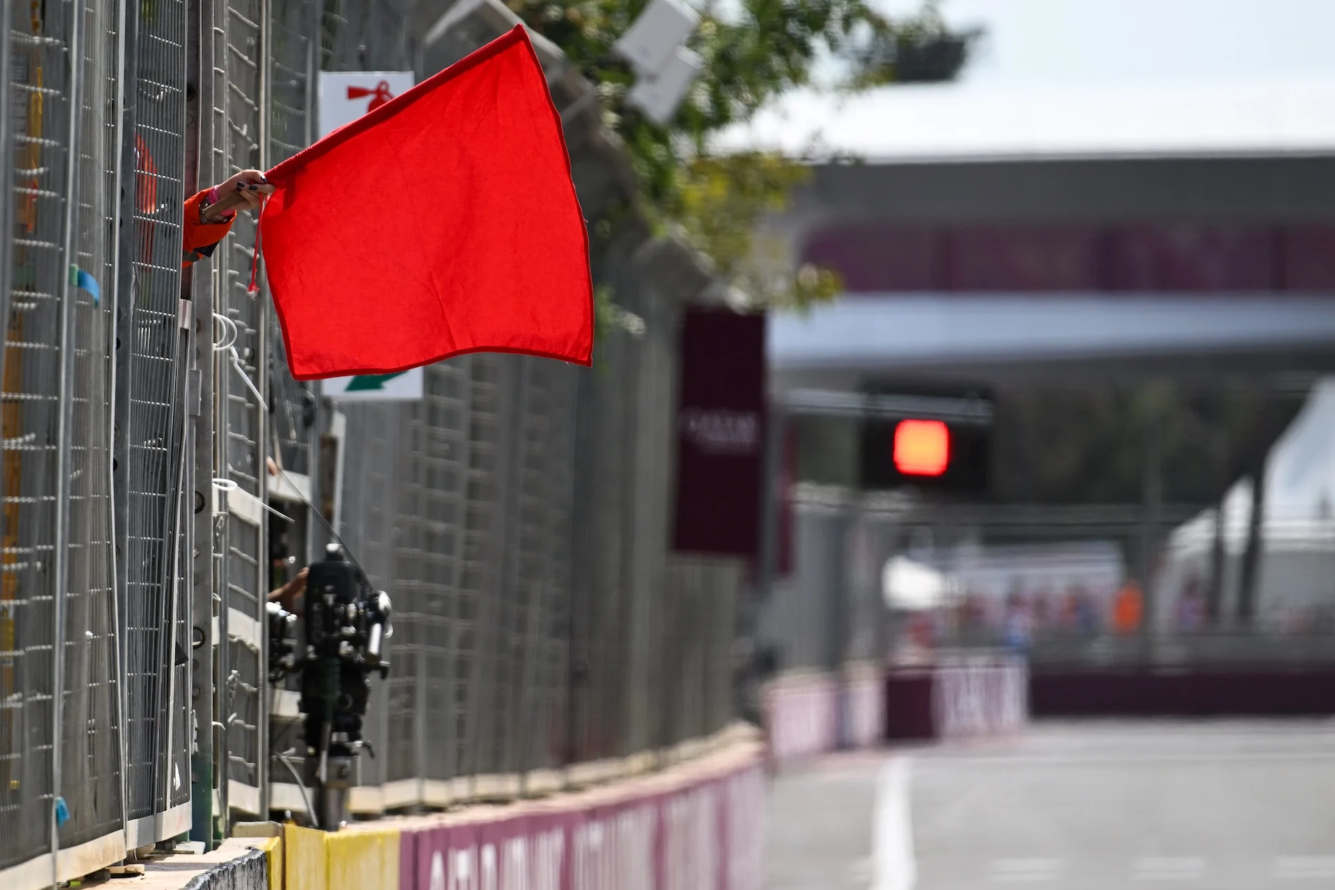 BAKU, AZERBAIJAN - SEPTEMBER 19: Marshals wave the red flag during practice ahead of the F1 Grand