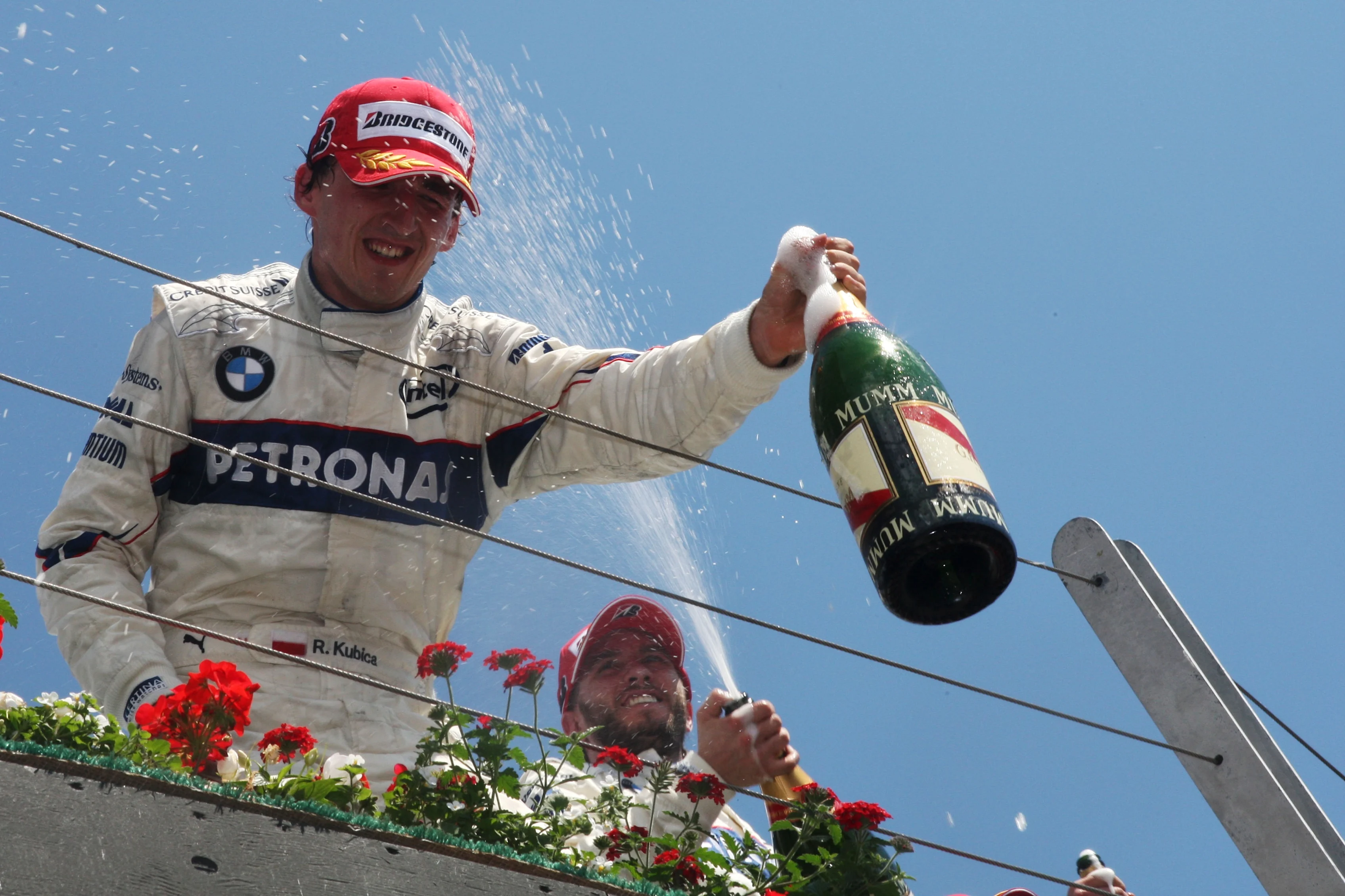 Robert Kubica (POL) BMW Sauber F1 celebrates his first GP win on the podium. Formula One World