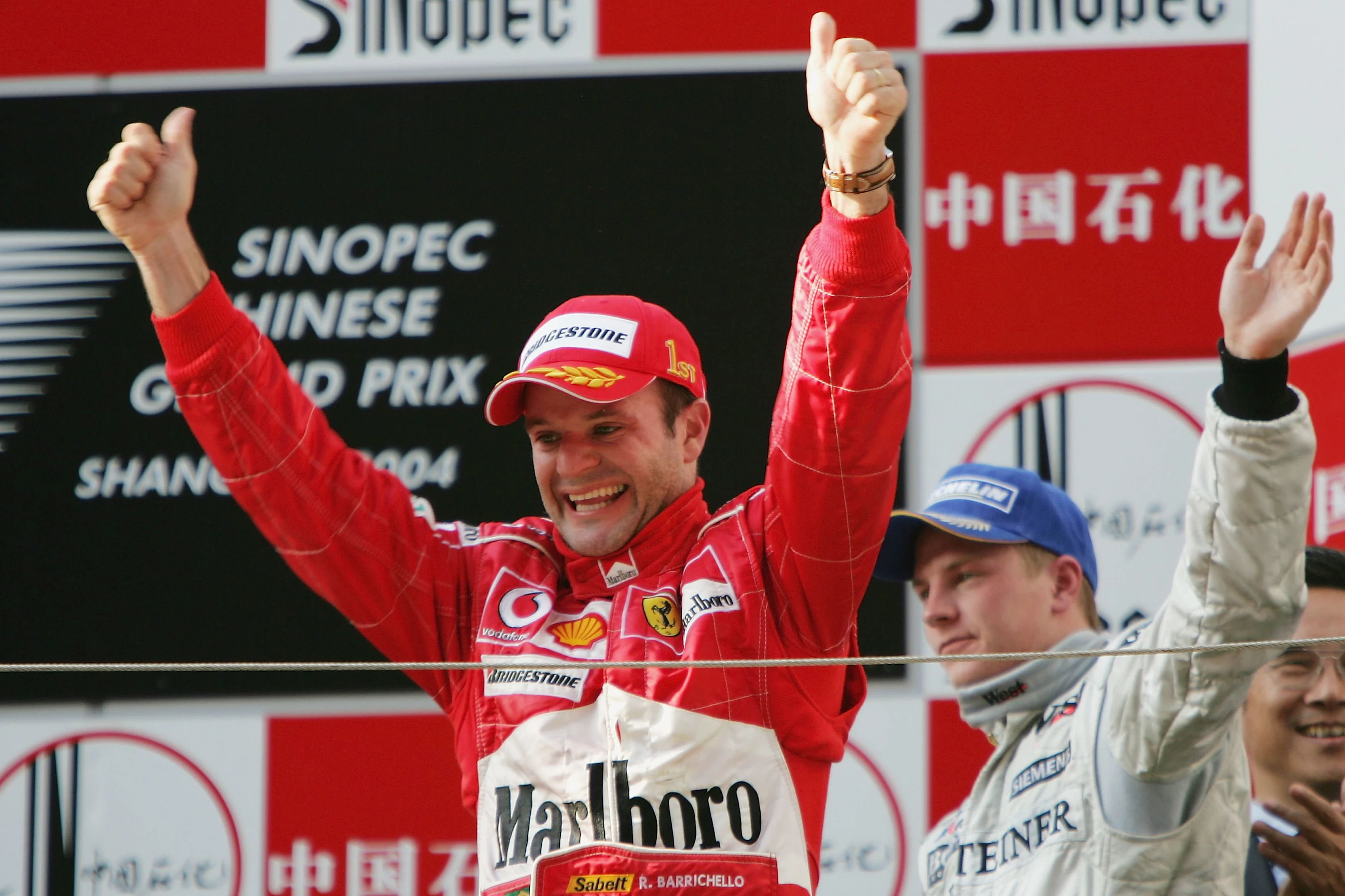 SHANGHAI, CHINA - SEPTEMBER 26: Rubens Barrichello of Brazil and Ferrari celebrates winning the