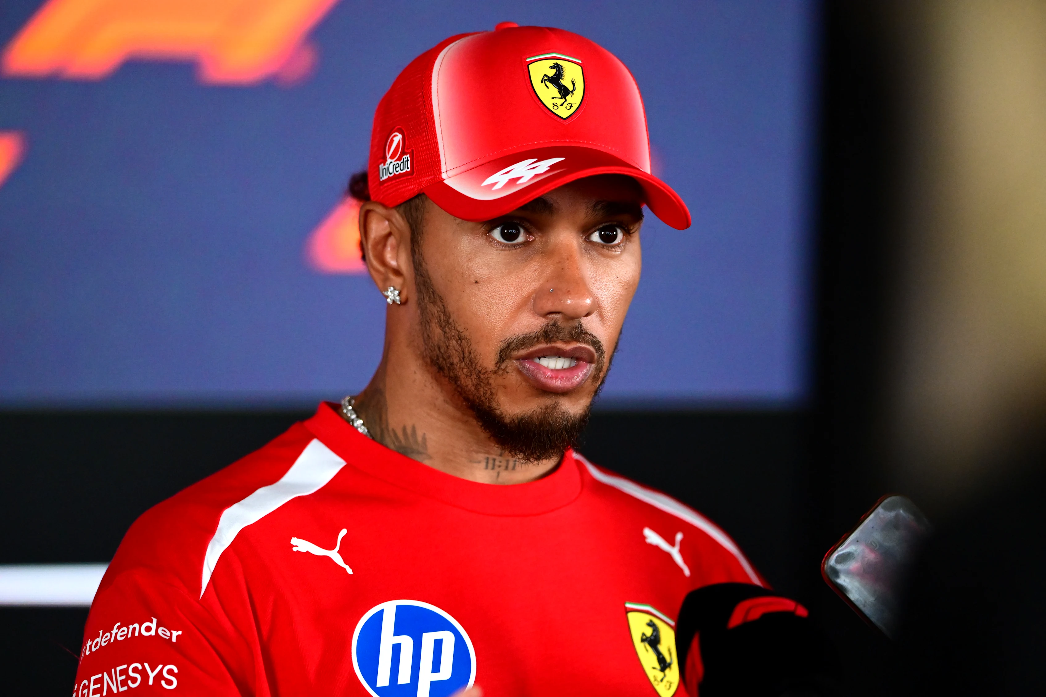 Lewis Hamilton of Scuderia Ferrari speaks at the media pen during media day of the Formula 1