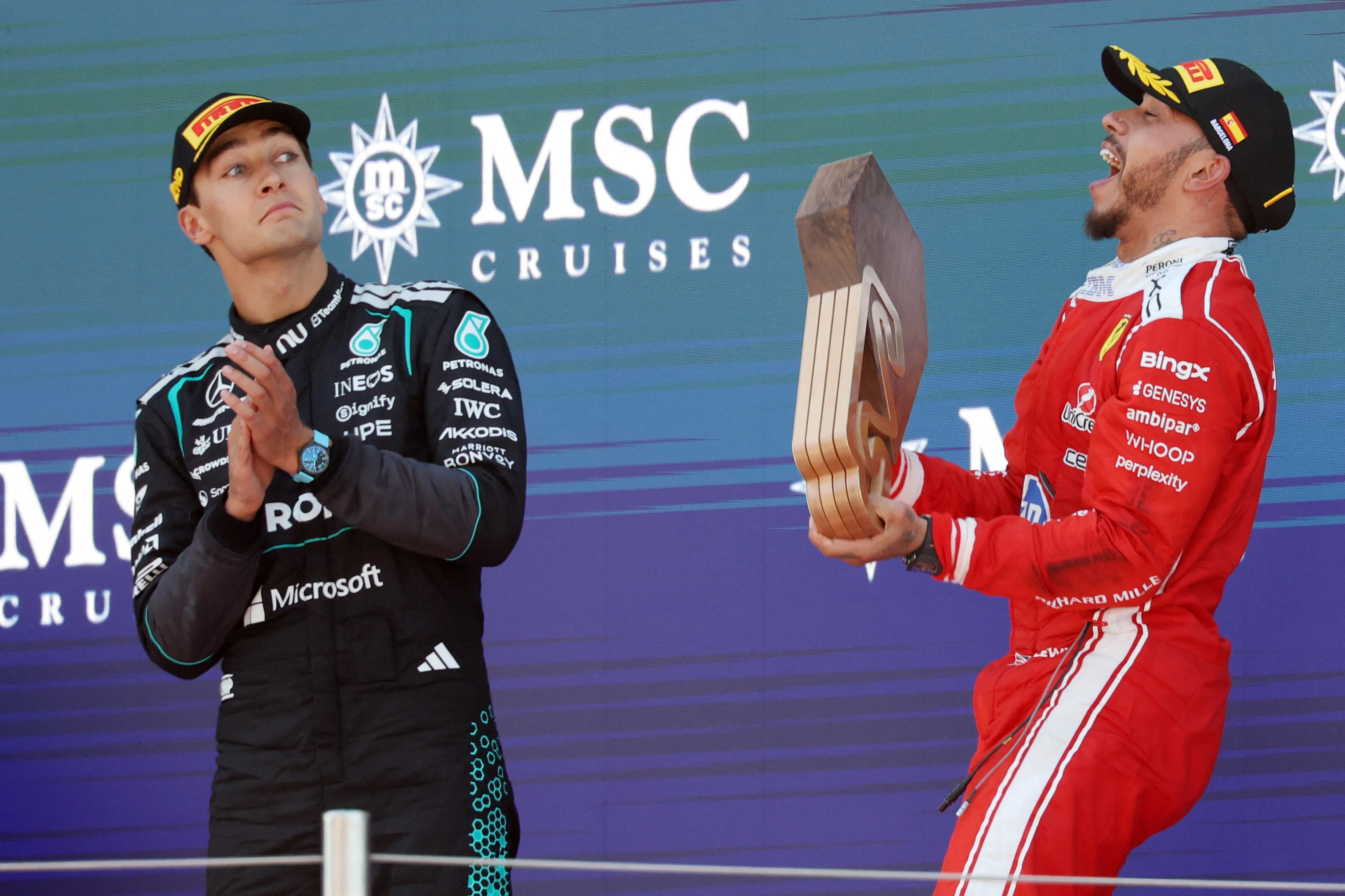 Winner Ferrari's British driver Lewis Hamilton (R) and second placed Mercedes' British driver