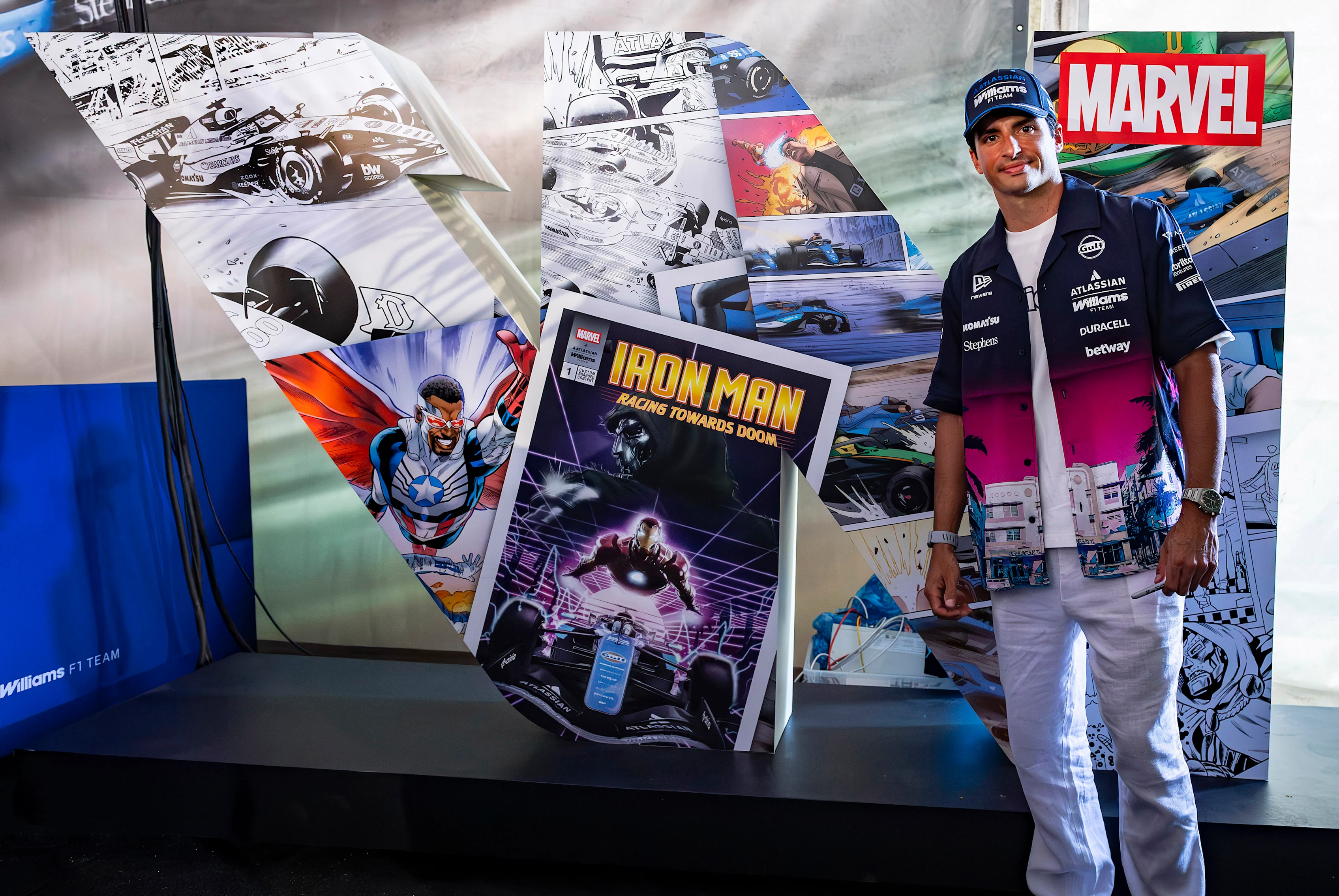 MIAMI, FLORIDA - APRIL 29: Carlos Sainz of Spain and Williams poses for a photo alongside Marvel