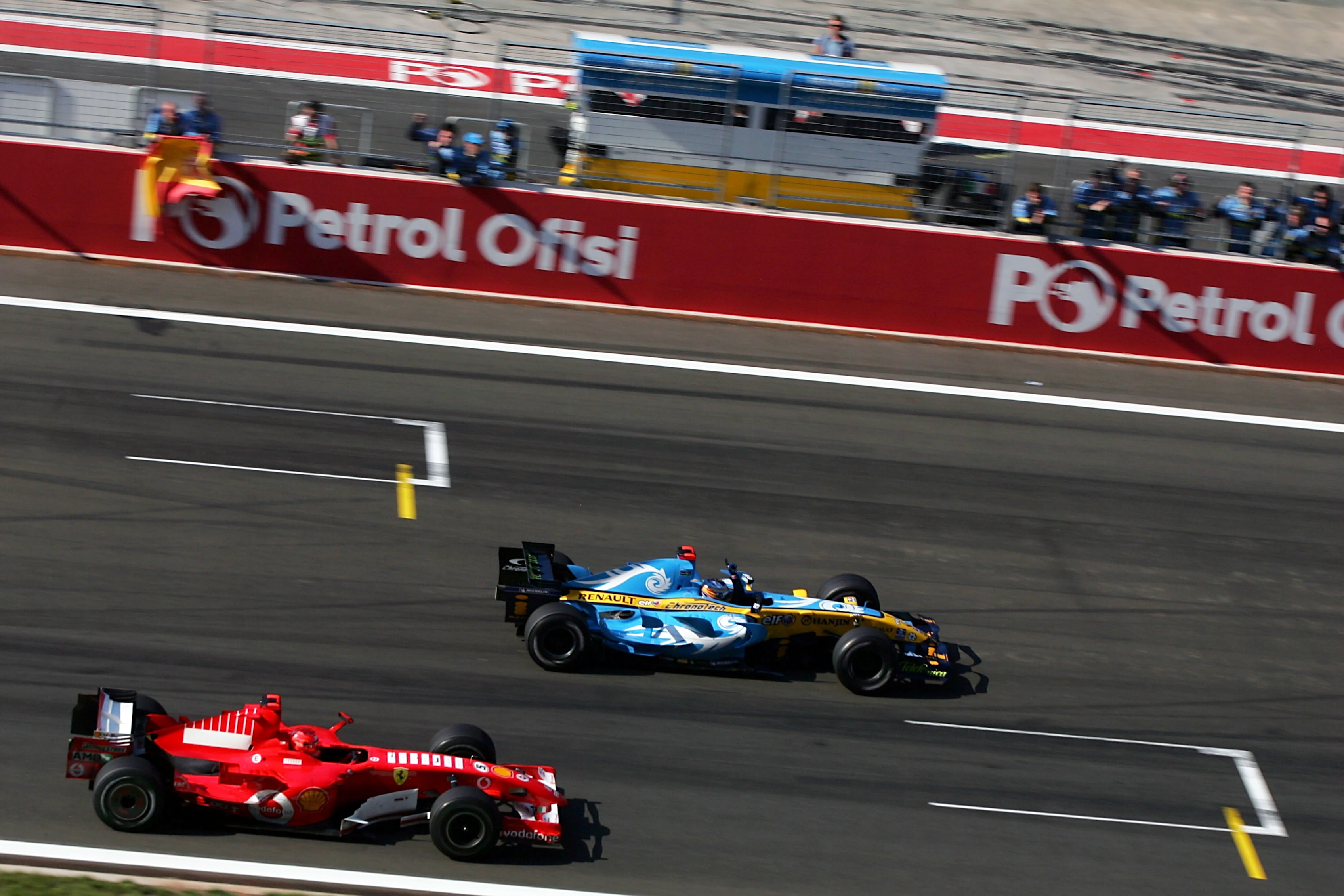 Fernando Alonso (ESP) Renault R26 crosses the line ahead of Michael Schumacher (GER) Ferrari 248 F1