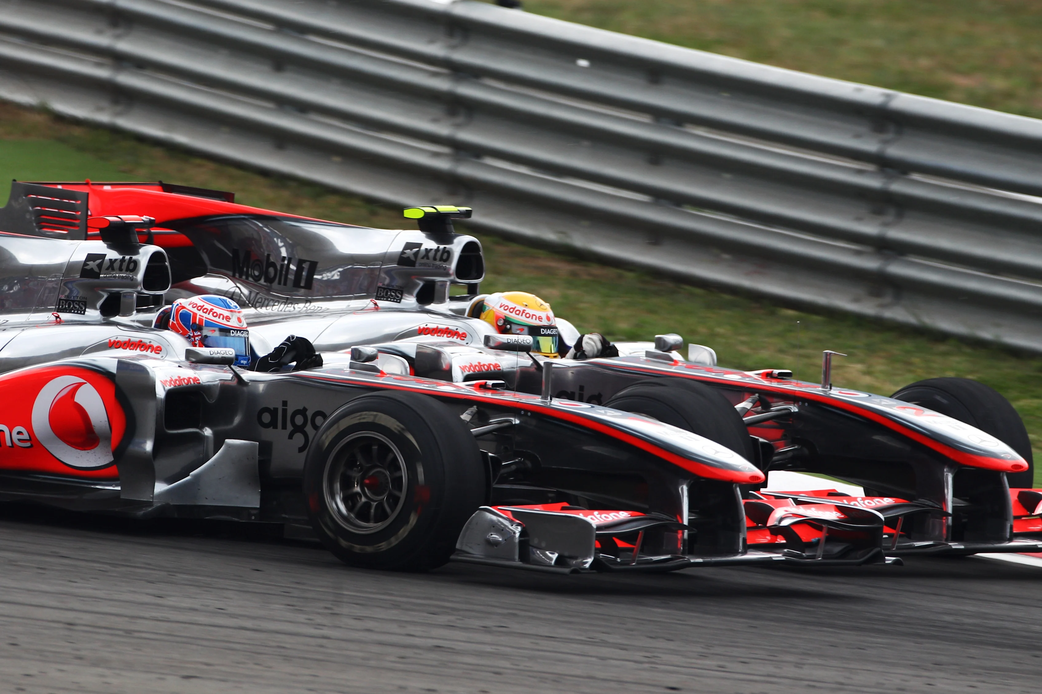 Jenson Button (GBR) McLaren MP4/25 and Lewis Hamilton (GBR) McLaren MP4/25 battle for position.