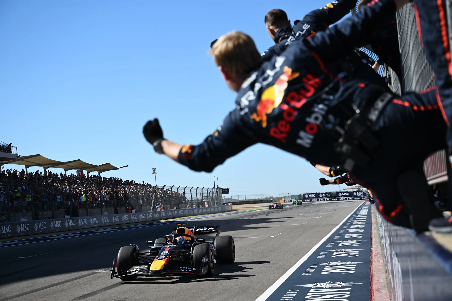 AUSTIN, TEXAS - OCTOBER 19: The Oracle Red Bull Racing team cheer as Race winner Max Verstappen of