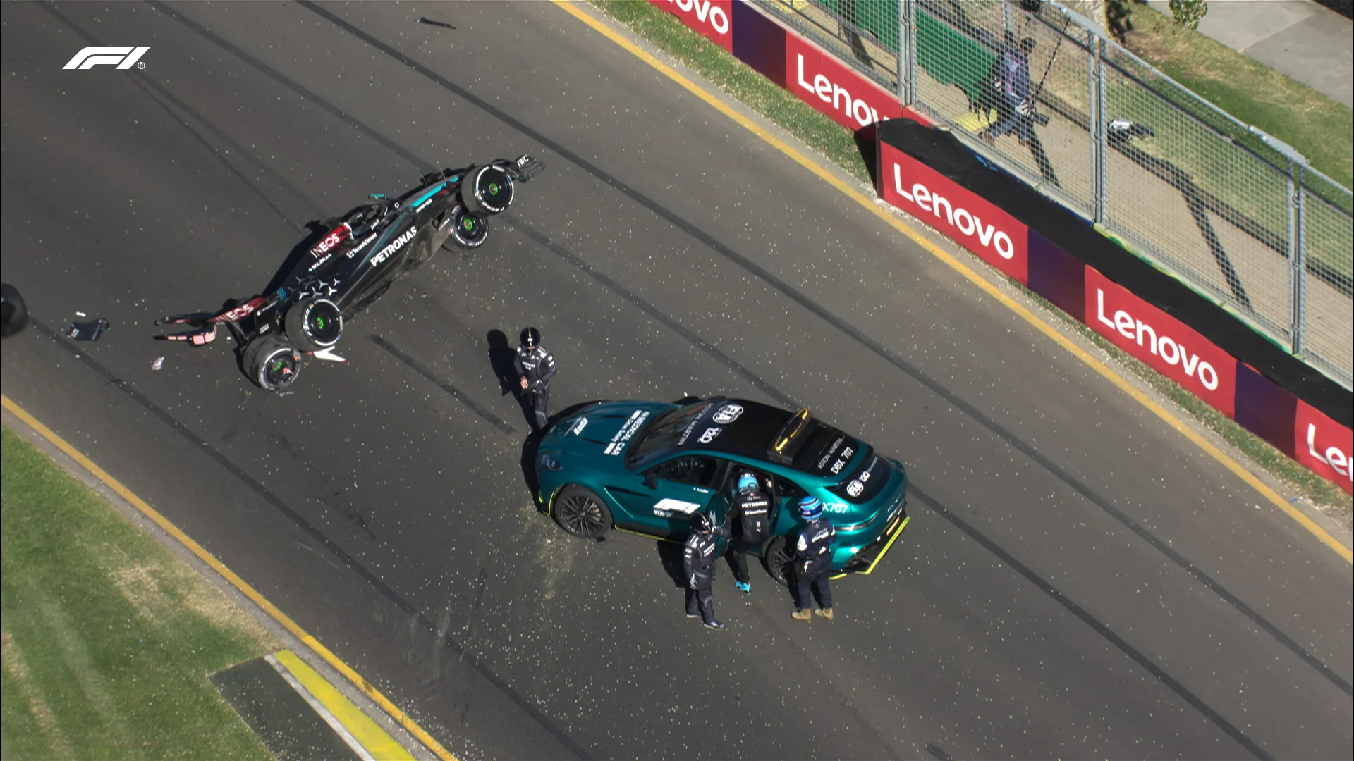 24 March 2024: George Russell getting in the medical car at the Australian Grand Prix as his Mercedes lies on its side further down the track