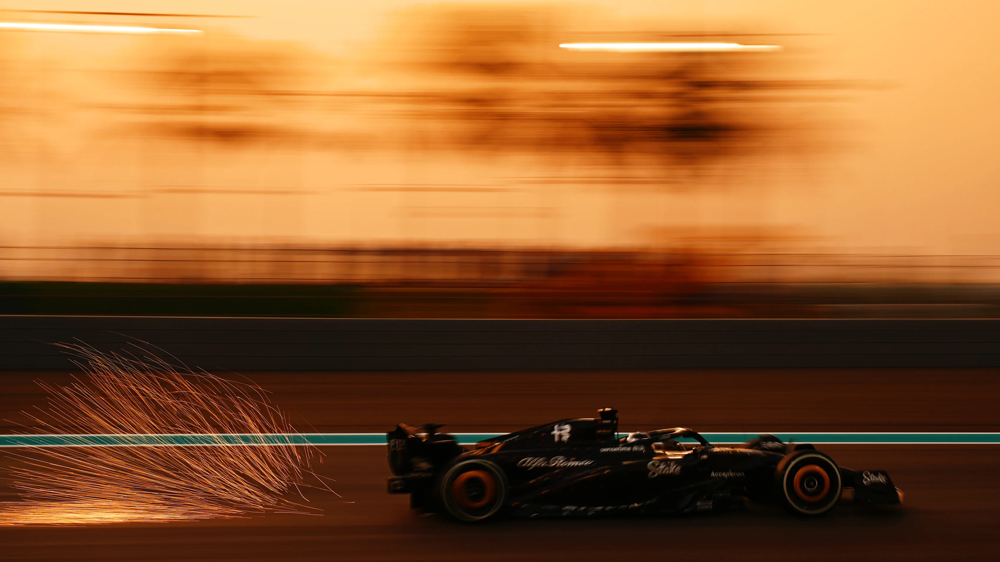 ABU DHABI, UNITED ARAB EMIRATES - NOVEMBER 24: Sparks fly behind Valtteri Bottas of Finland driving the (77) Alfa Romeo F1 C43 Ferrari during practice ahead of the F1 Grand Prix of Abu Dhabi at Yas Marina Circuit on November 24, 2023 in Abu Dhabi, United Arab Emirates. (Photo by Clive Mason - Formula 1/Formula 1 via Getty Images)