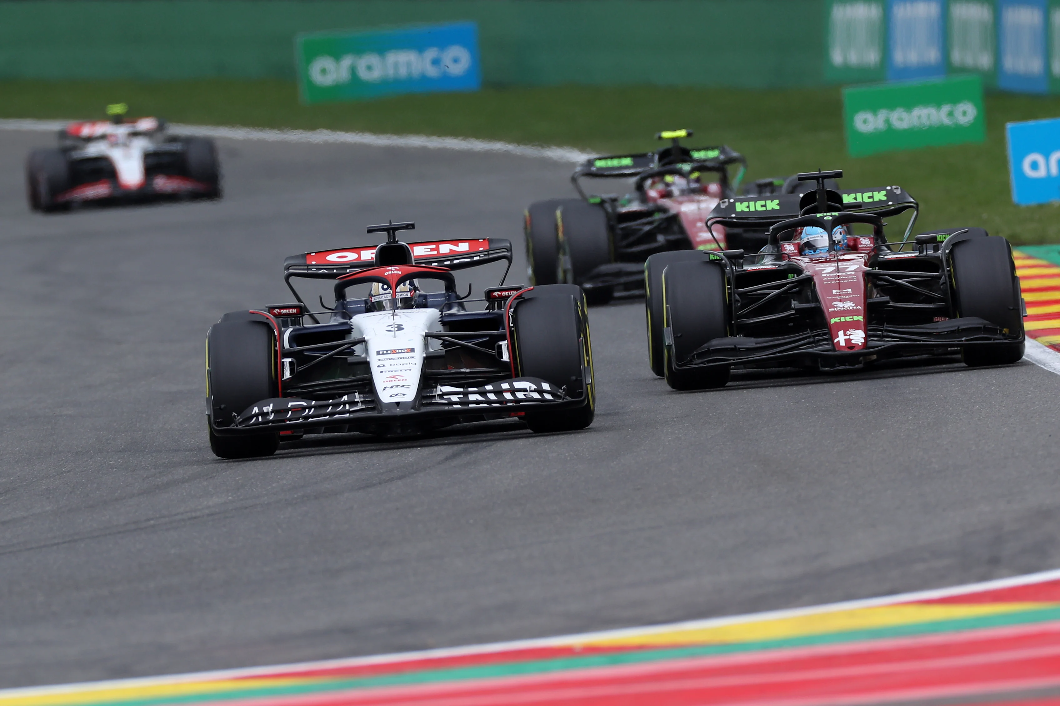 SPA, BELGIUM - JULY 30: Daniel Ricciardo of Australia driving the (3) Scuderia AlphaTauri AT04 leads Valtteri Bottas of Finland driving the (77) Alfa Romeo F1 C43 Ferrari during the F1 Grand Prix of Belgium at Circuit de Spa-Francorchamps on July 30, 2023 in Spa, Belgium. (Photo by Peter Fox/Getty Images)