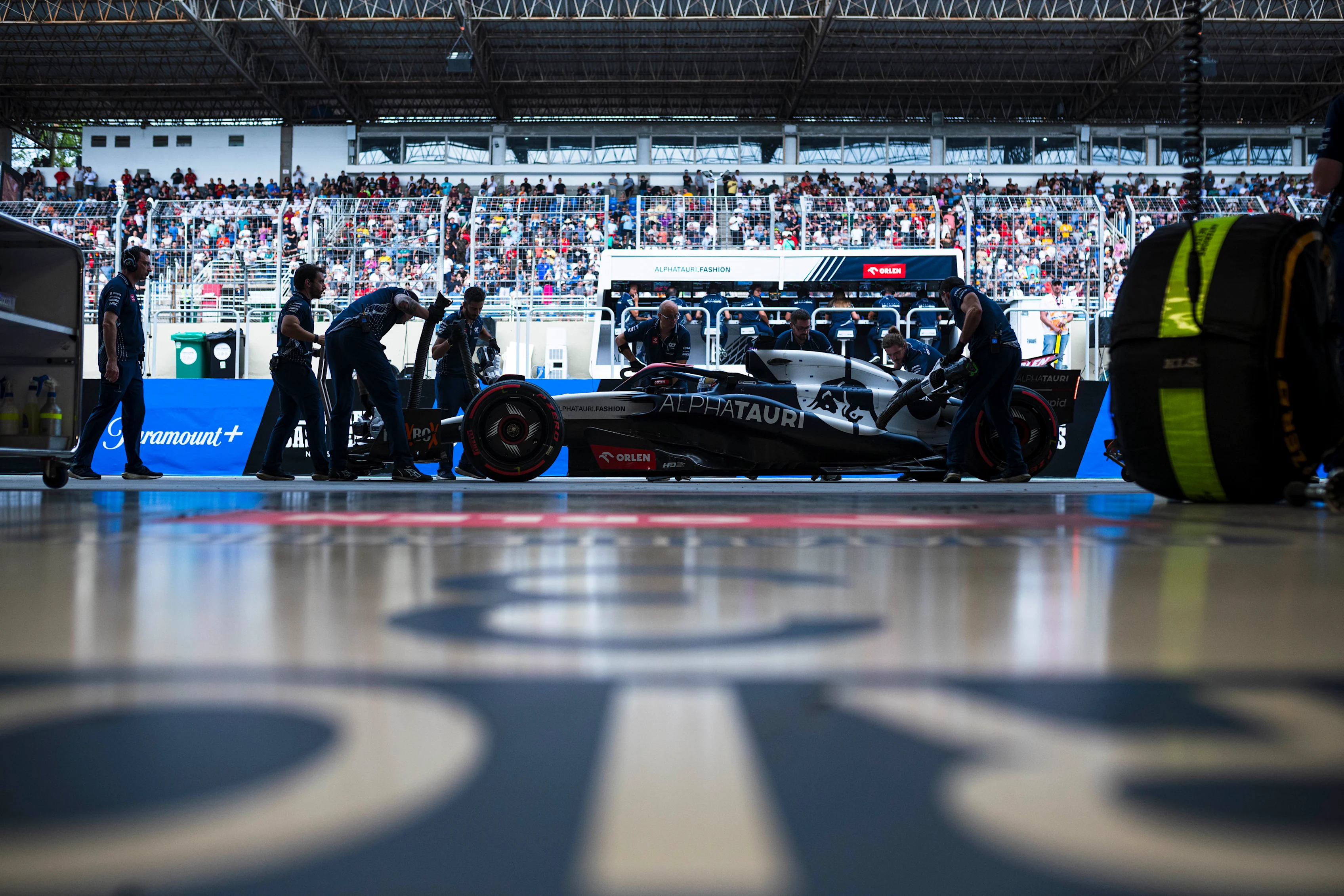 SAO PAULO, BRAZIL - NOVEMBER 03: Daniel Ricciardo of Australia and Scuderia AlphaTauri is pushed back into the garage during qualifying ahead of the F1 Grand Prix of Brazil at Autodromo Jose Carlos Pace on November 03, 2023 in Sao Paulo, Brazil. (Photo by Rudy Carezzevoli/Getty Images)