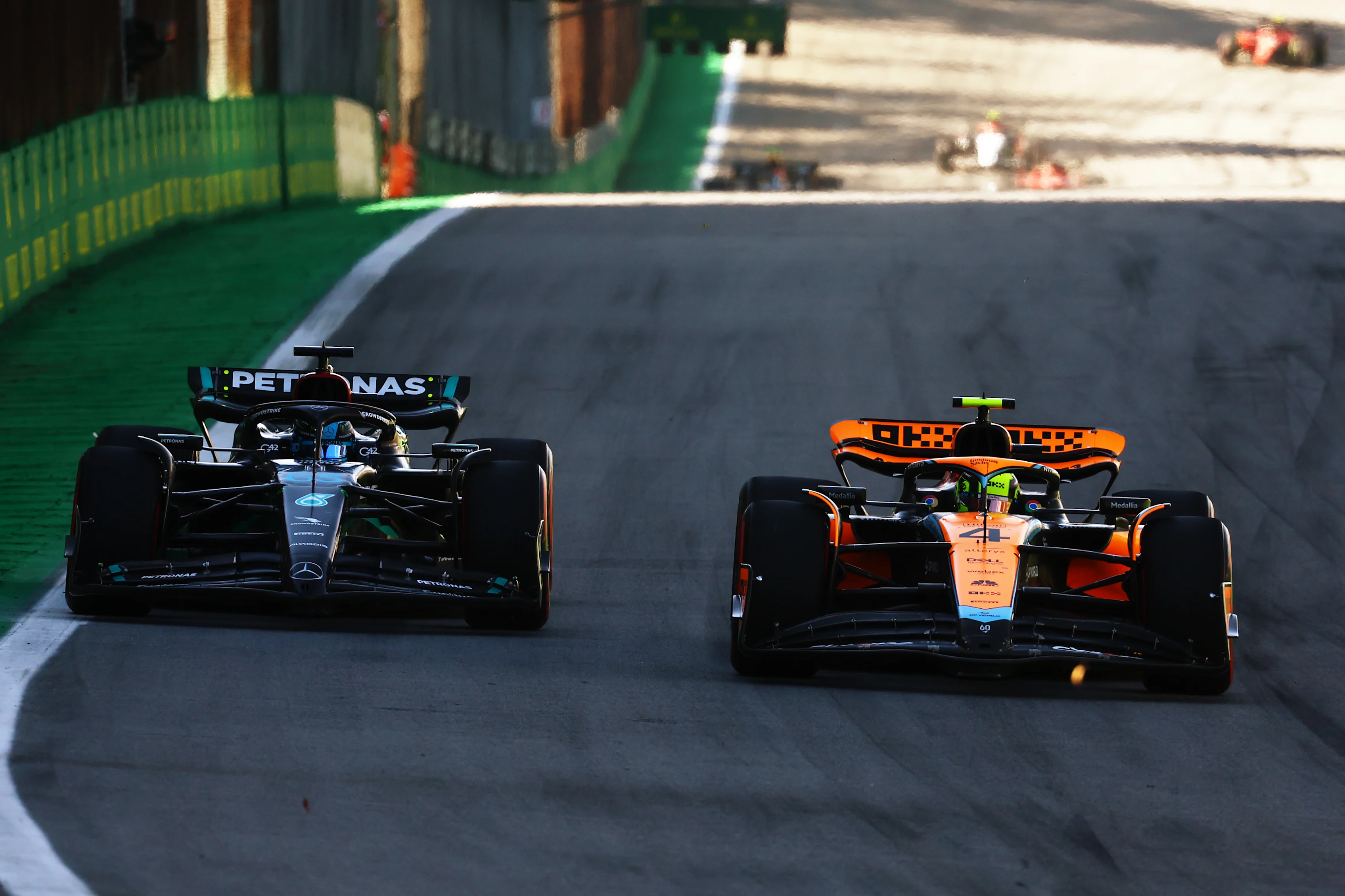 SAO PAULO, BRAZIL - NOVEMBER 04: Lando Norris of Great Britain driving the (4) McLaren MCL60 Mercedes leads George Russell of Great Britain driving the (63) Mercedes AMG Petronas F1 Team W14 on track during the Sprint ahead of the F1 Grand Prix of Brazil at Autodromo Jose Carlos Pace on November 04, 2023 in Sao Paulo, Brazil. (Photo by Mark Thompson/Getty Images)