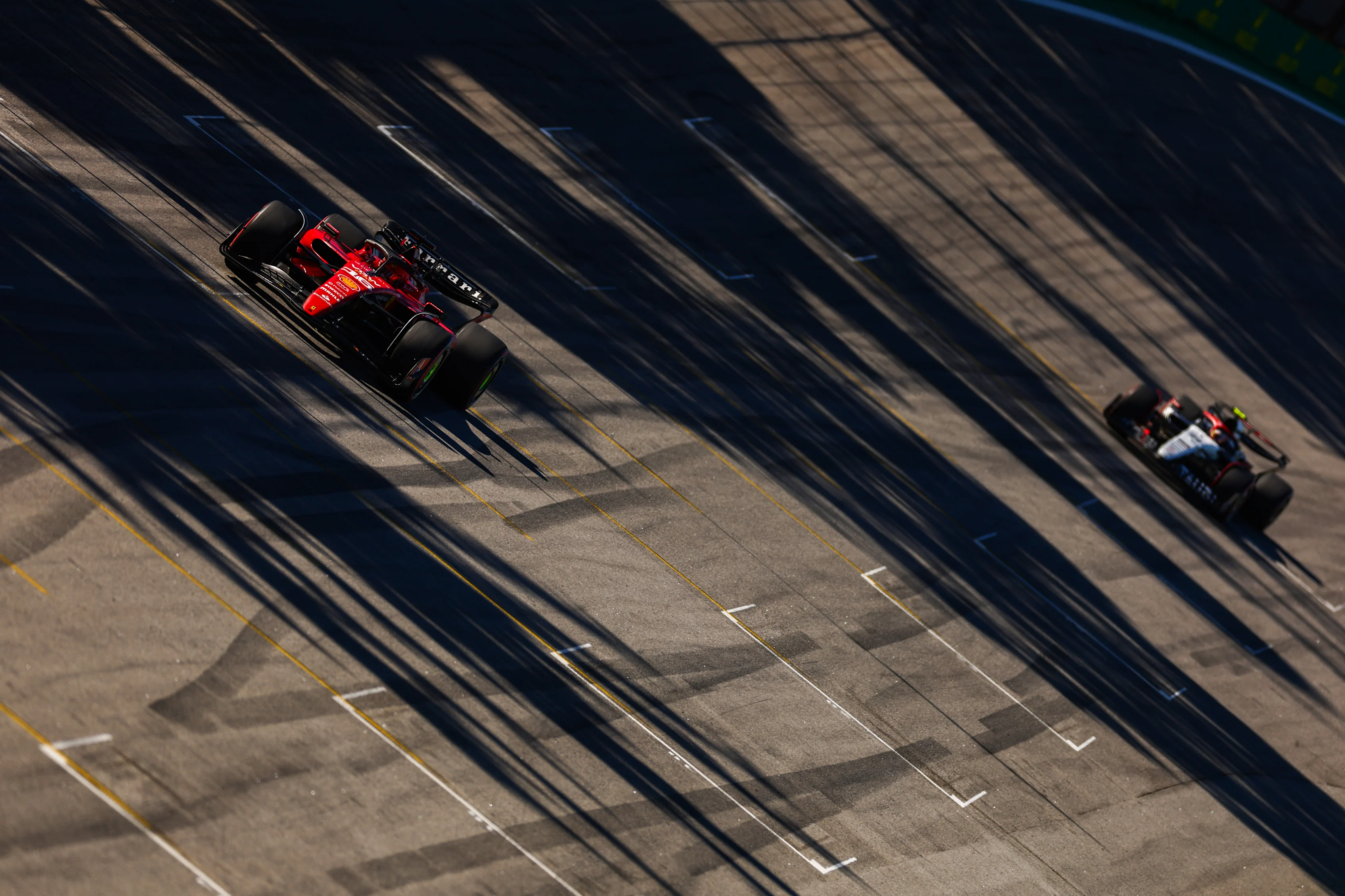 SAO PAULO, BRAZIL - NOVEMBER 04: Charles Leclerc of Monaco driving the (16) Ferrari SF-23 leads Yuki Tsunoda of Japan driving the (22) Scuderia AlphaTauri AT04 on track during the Sprint ahead of the F1 Grand Prix of Brazil at Autodromo Jose Carlos Pace on November 04, 2023 in Sao Paulo, Brazil. (Photo by Dan Istitene - Formula 1/Formula 1 via Getty Images)