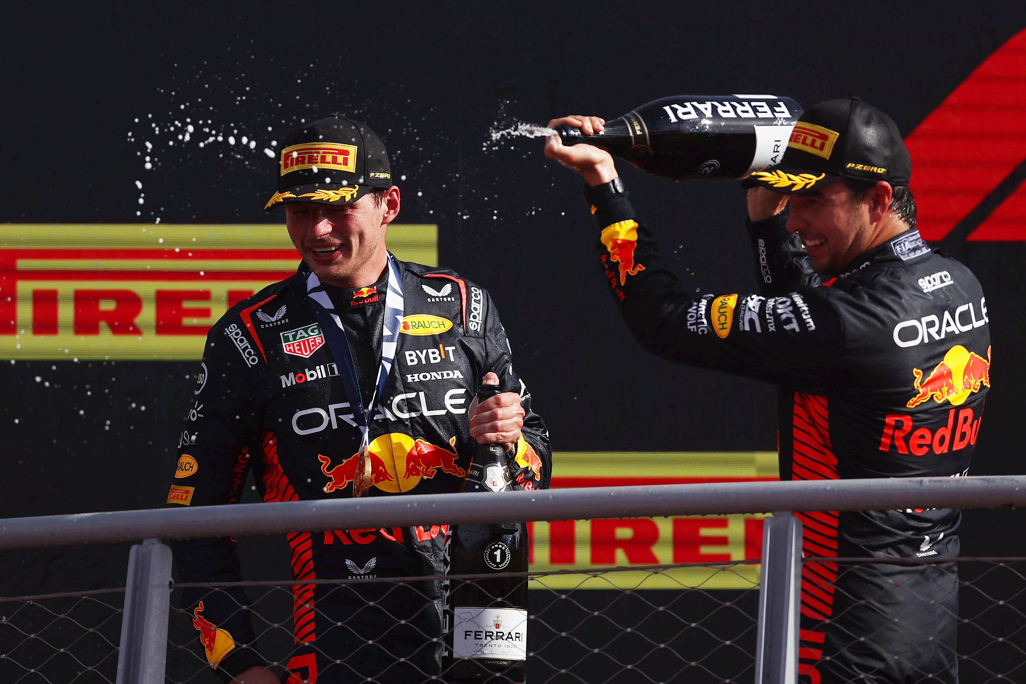 MONZA, ITALY - SEPTEMBER 03: Race winner Max Verstappen of the Netherlands and Oracle Red Bull Racing and Second placed Sergio Perez of Mexico and Oracle Red Bull Racing celebrate on the podium during the F1 Grand Prix of Italy at Autodromo Nazionale Monza on September 03, 2023 in Monza, Italy. (Photo by Ryan Pierse/Getty Images)