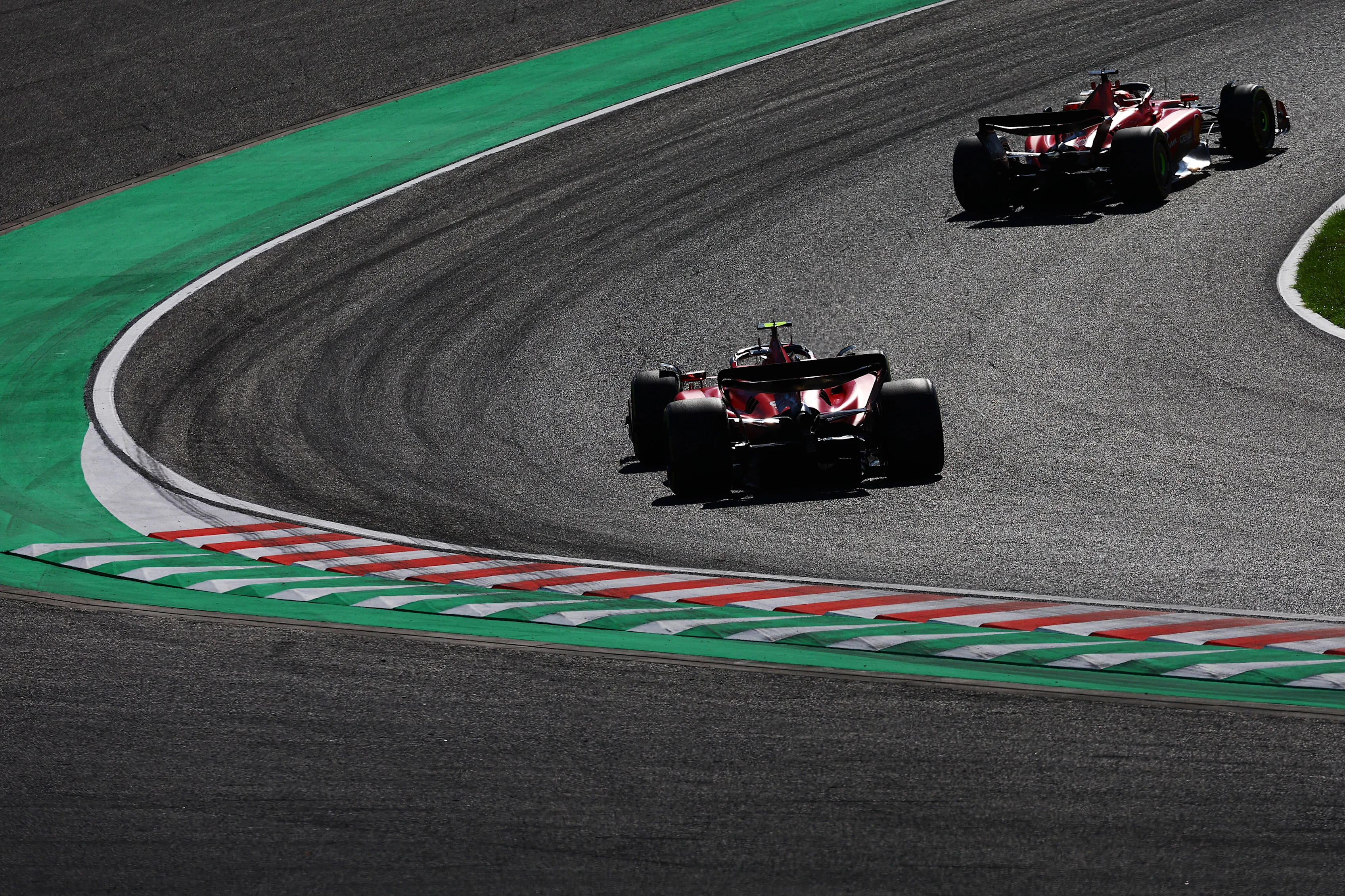 SUZUKA, JAPAN - SEPTEMBER 24: Charles Leclerc of Monaco driving the (16) Ferrari SF-23 leads Carlos
