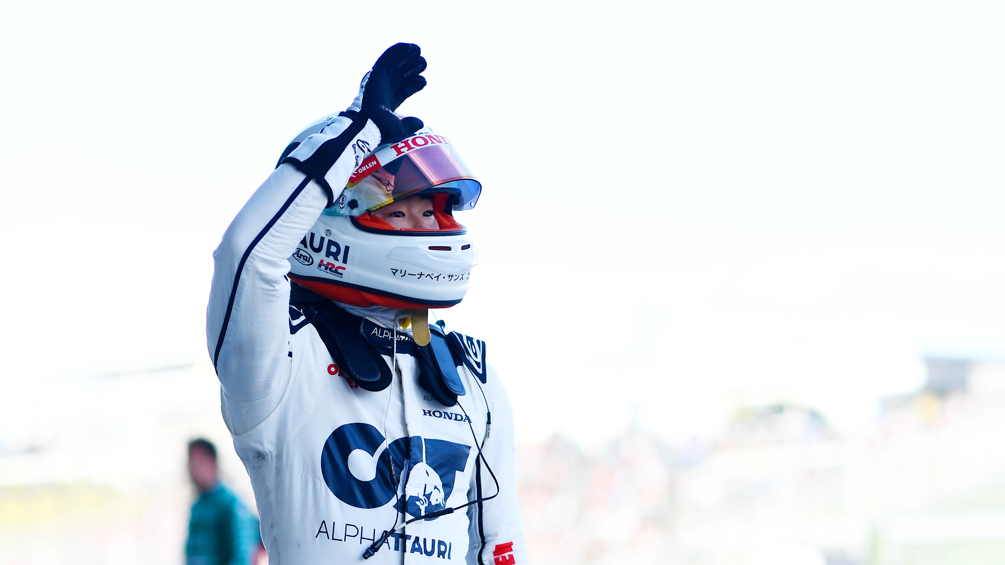 SUZUKA, JAPAN - SEPTEMBER 23: 9th placed qualifier Yuki Tsunoda of Japan and Scuderia AlphaTauri waves to the crowd from parc ferme during qualifying ahead of the F1 Grand Prix of Japan at Suzuka International Racing Course on September 23, 2023 in Suzuka, Japan. (Photo by Rudy Carezzevoli/Getty Images)