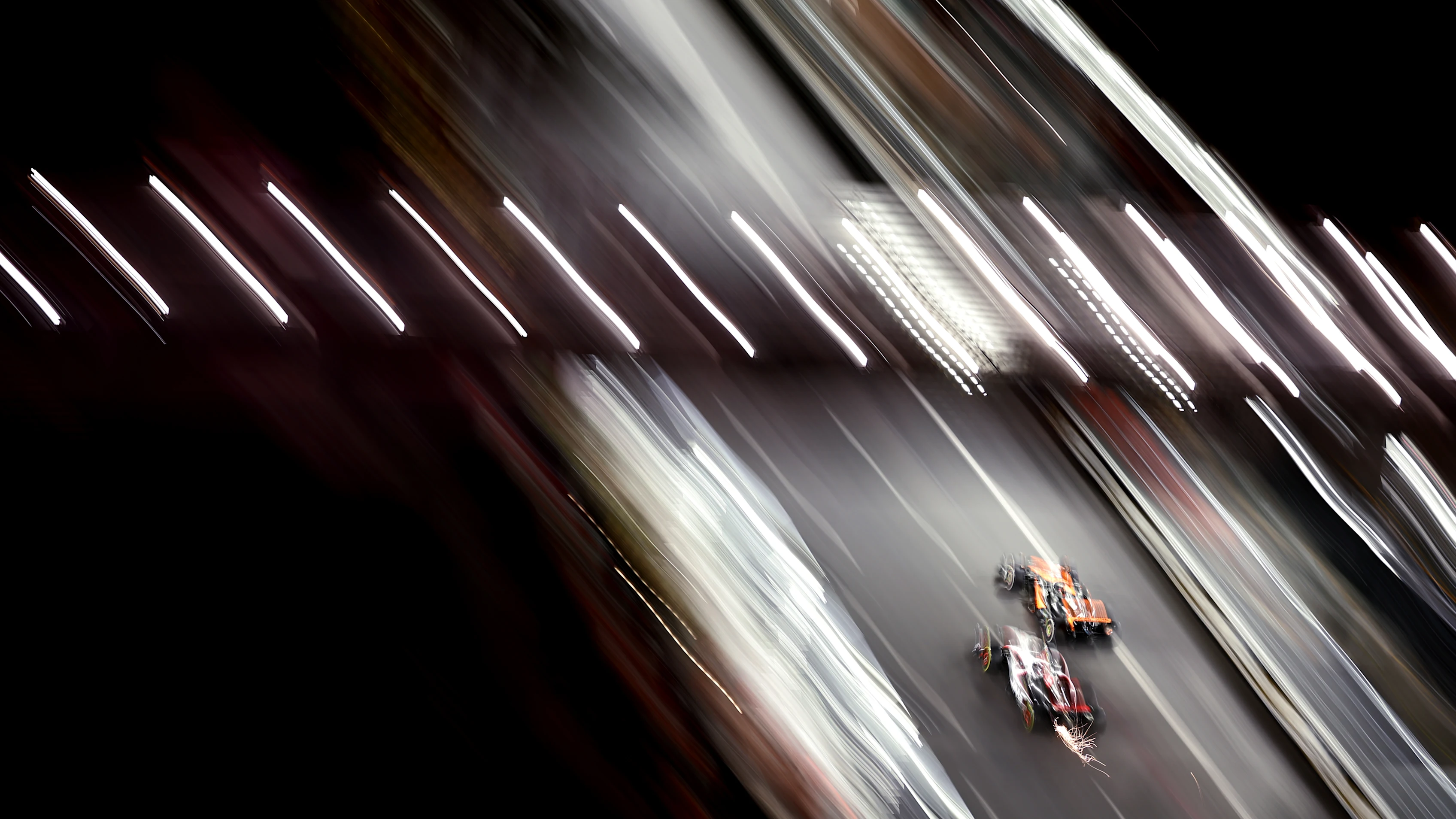 LAS VEGAS, NEVADA - NOVEMBER 18: Oscar Piastri of Australia driving the (81) McLaren MCL60 Mercedes leads Kevin Magnussen of Denmark driving the (20) Haas F1 VF-23 Ferrari on track as seen from the McLaren VISTA during the F1 Grand Prix of Las Vegas at Las Vegas Strip Circuit on November 18, 2023 in Las Vegas, Nevada. (Photo by Jared C. Tilton - Formula 1/Formula 1 via Getty Images)
